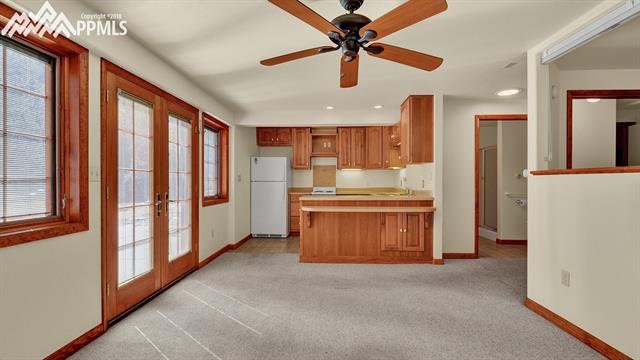 6230 Sand Gulch Road Cascade, CO 80809 - Photo 16 of 20 Spacious living/kitchen area in lower level, bright and open, large concrete pad for parking and patio area.