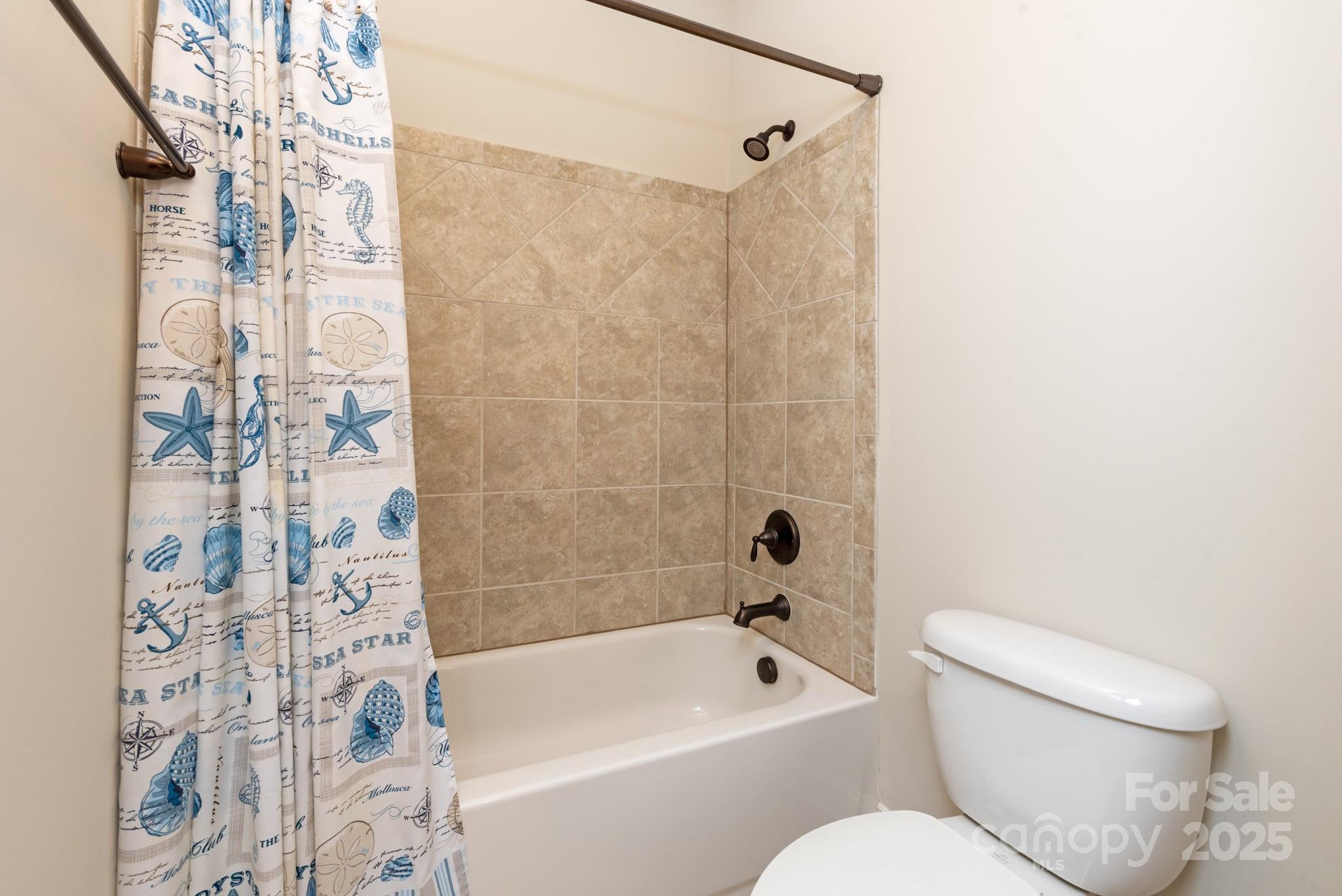 83202 Cortland Drive Lancaster, SC 29720 - Photo 25 of 47 a bathroom with a toilet and a bathtub