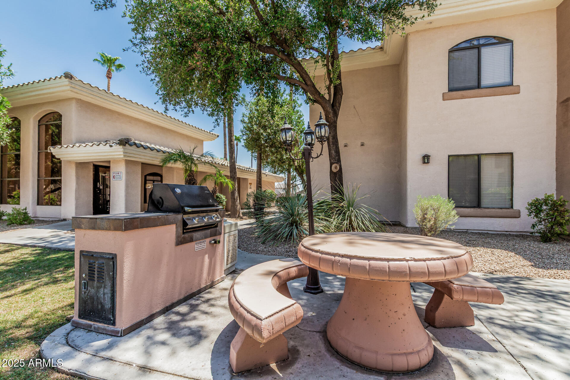 a view of a patio with couches table and chairs and potted plants