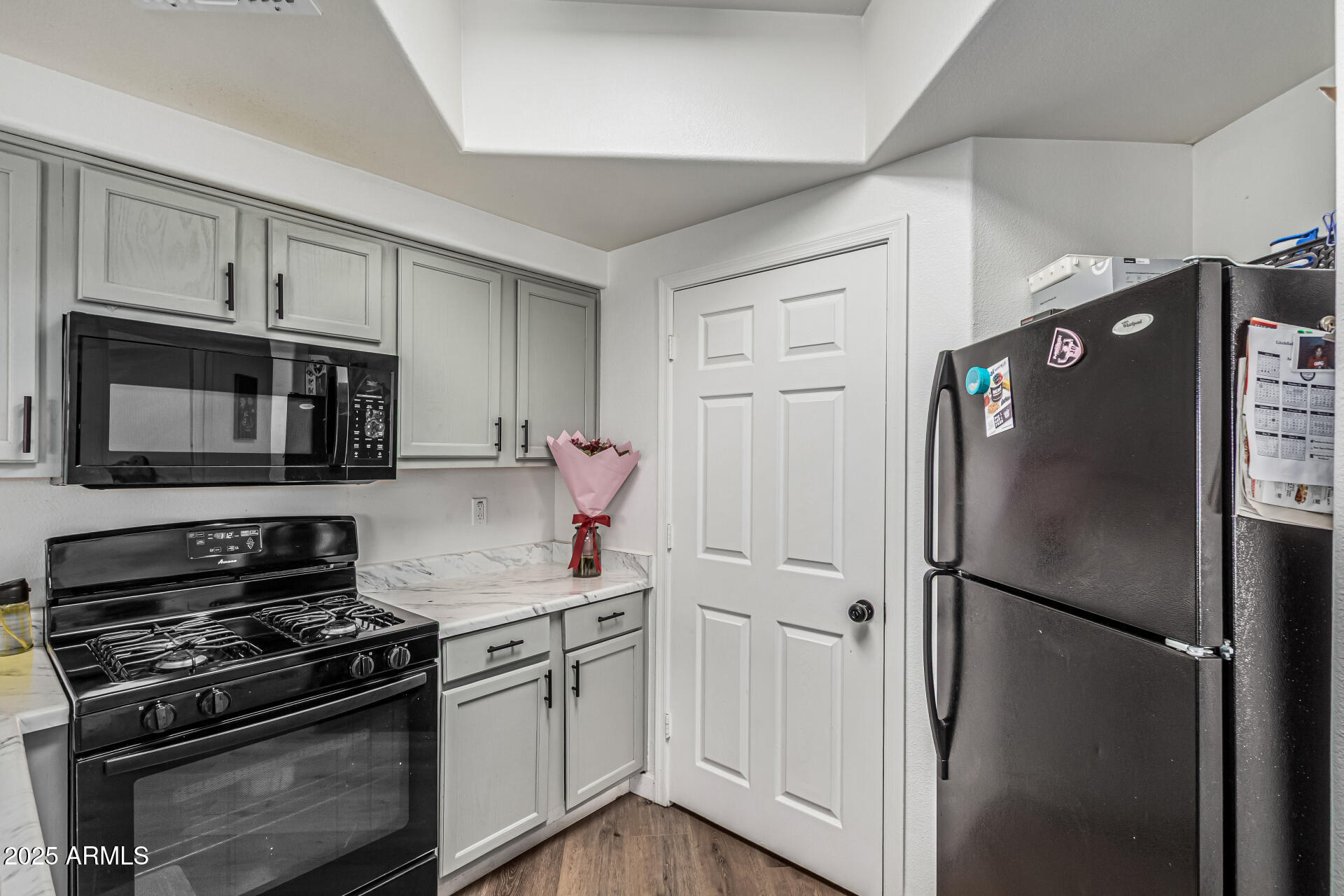 10030 West Indian School Road, Unit 255 Phoenix, AZ 85037 - Photo 11 of 26 a kitchen with stainless steel appliances and refrigerator