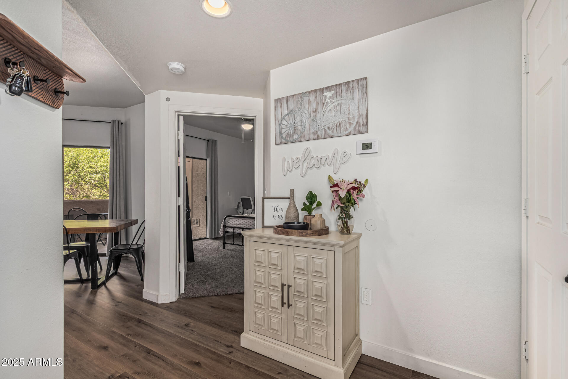 10030 West Indian School Road, Unit 255 Phoenix, AZ 85037 - Photo 2 of 26 a dining room with furniture and wooden floor