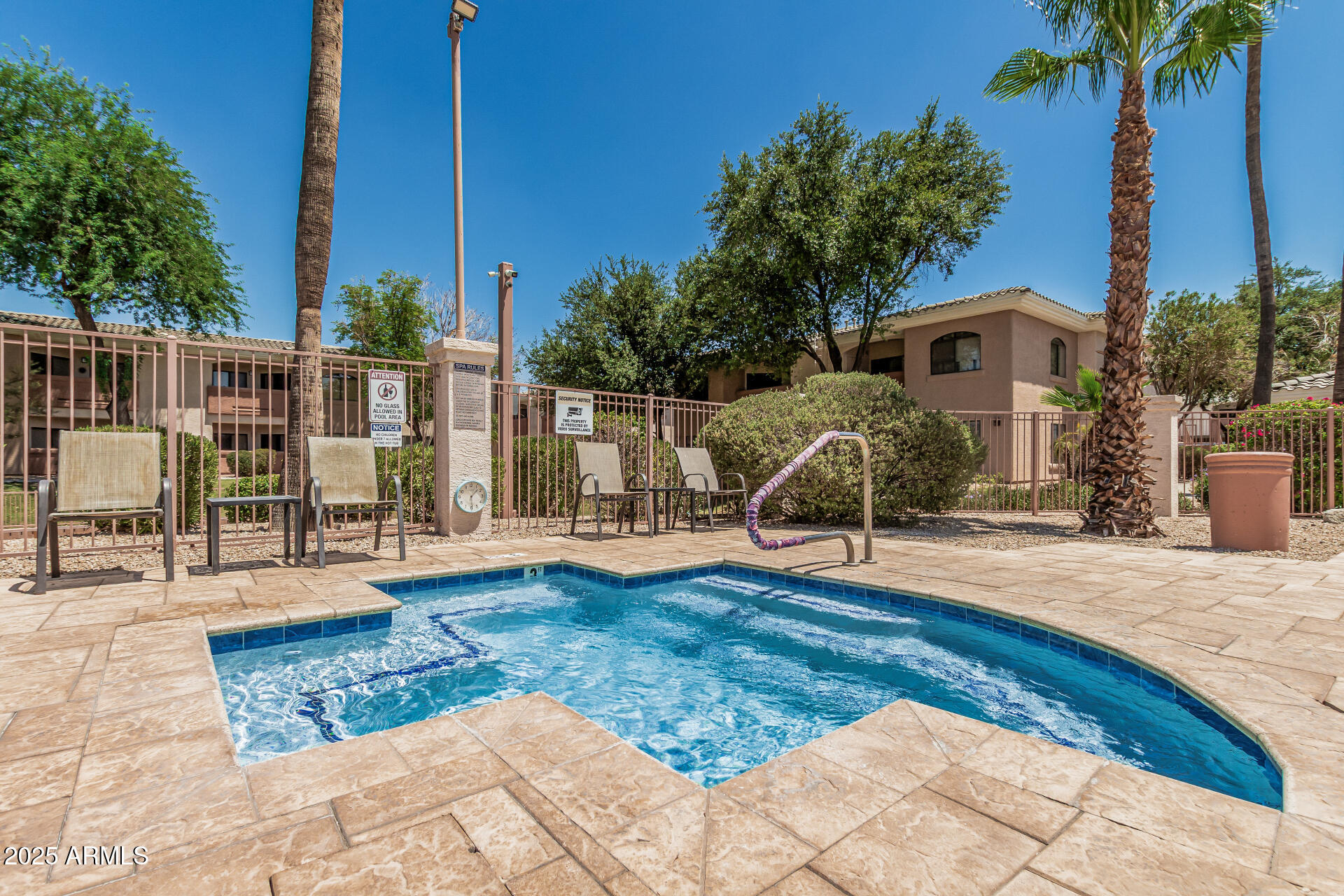 10030 West Indian School Road, Unit 255 Phoenix, AZ 85037 - Photo 24 of 26 a view of a swimming pool with a lounge chair