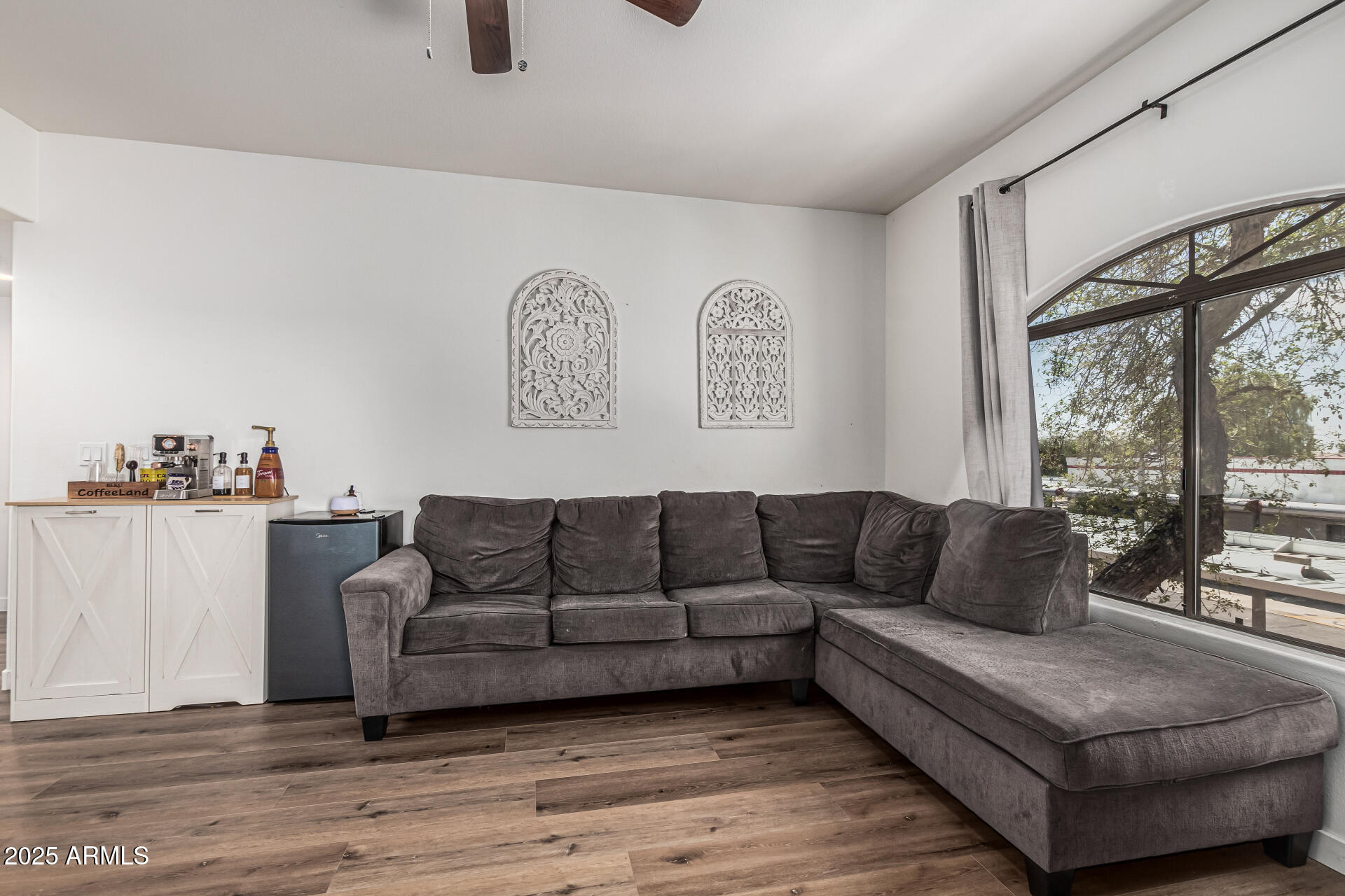 10030 West Indian School Road, Unit 255 Phoenix, AZ 85037 - Photo 5 of 26 a living room with furniture and a large window