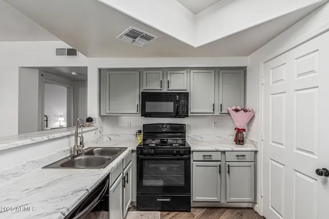 a kitchen with a sink stove and refrigerator