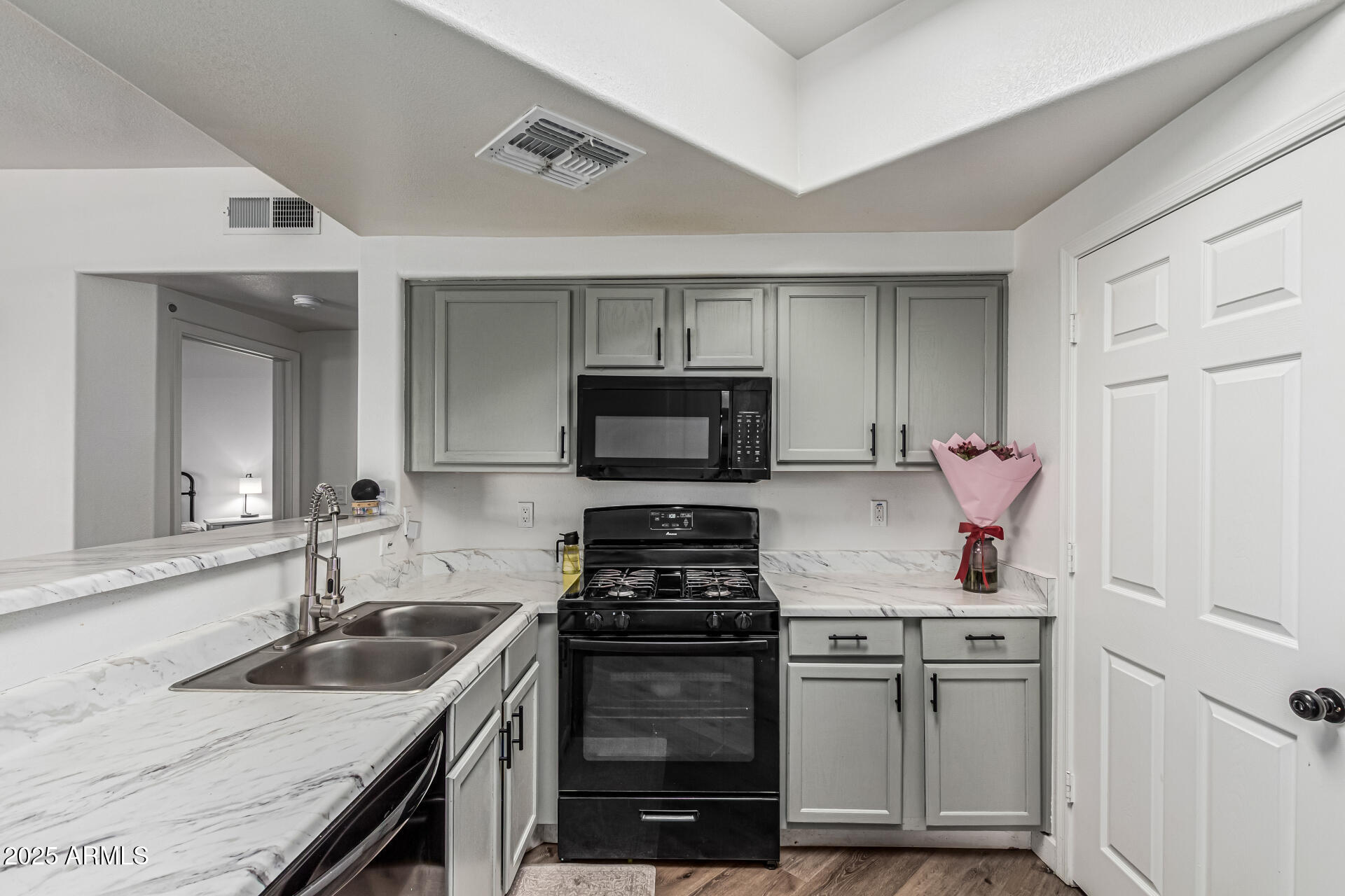 10030 West Indian School Road, Unit 255 Phoenix, AZ 85037 - Photo 9 of 26 a kitchen with a sink stove and refrigerator