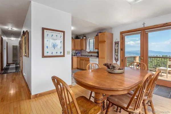 a dining room with furniture and wooden floor