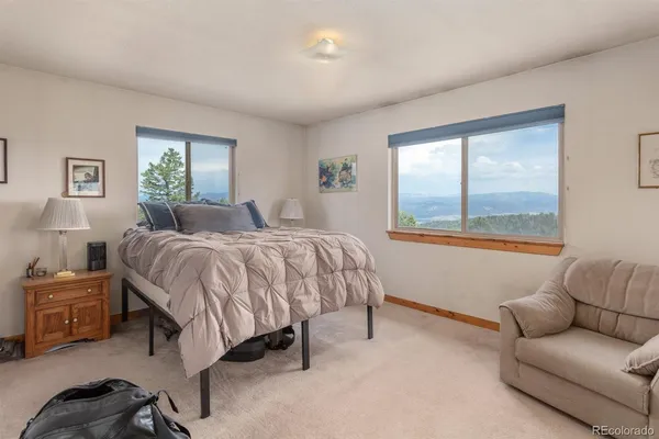 a bedroom with a bed couch and window