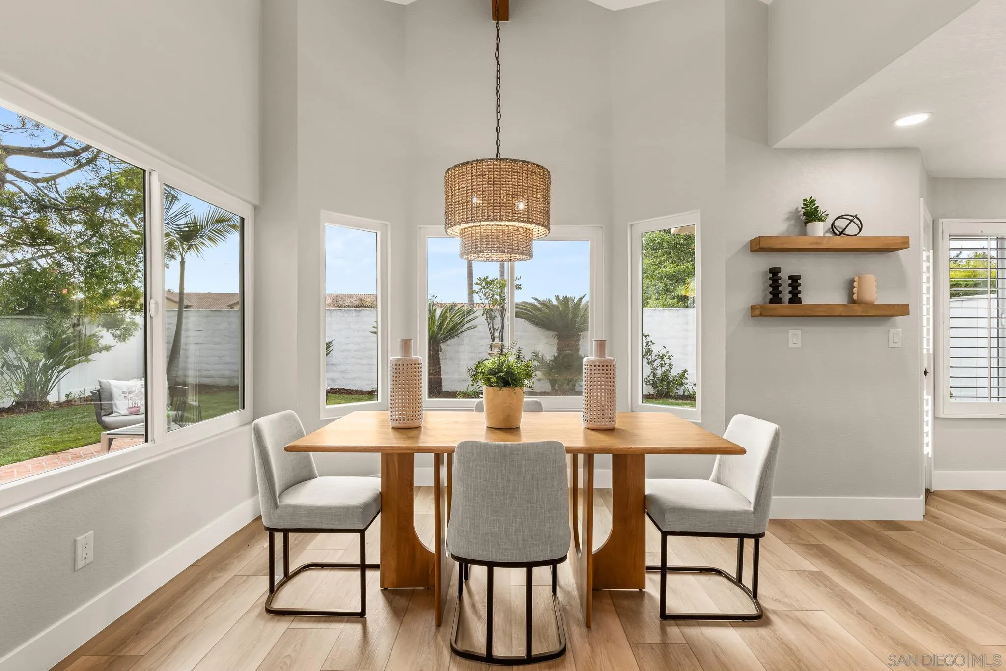 4661 Majorca Way Oceanside, CA 92056 - Photo 11 of 64 a dining room with furniture a chandelier and wooden floor