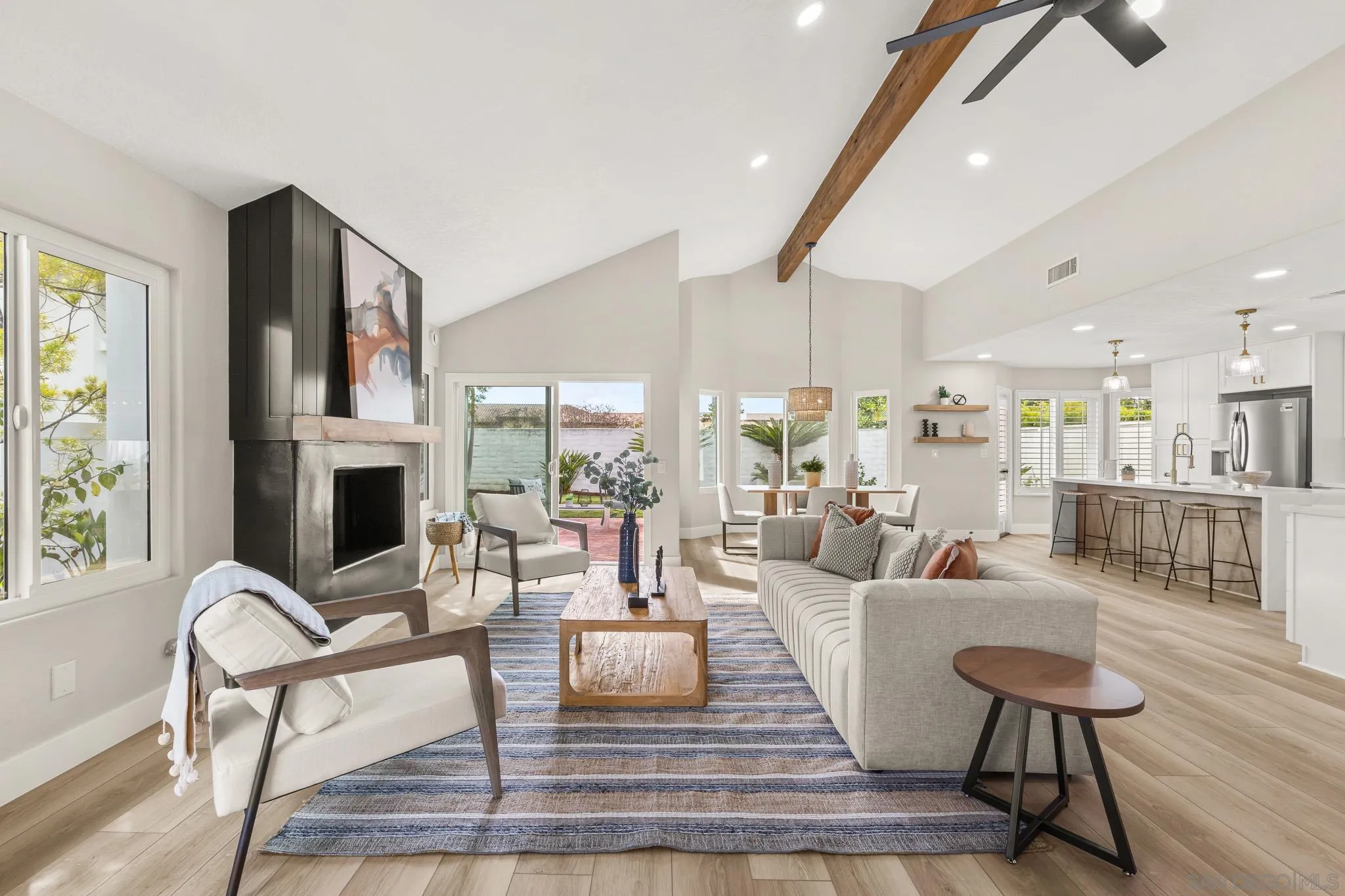 4661 Majorca Way Oceanside, CA 92056 - Photo 21 of 64 a living room with fireplace furniture and a floor to ceiling window