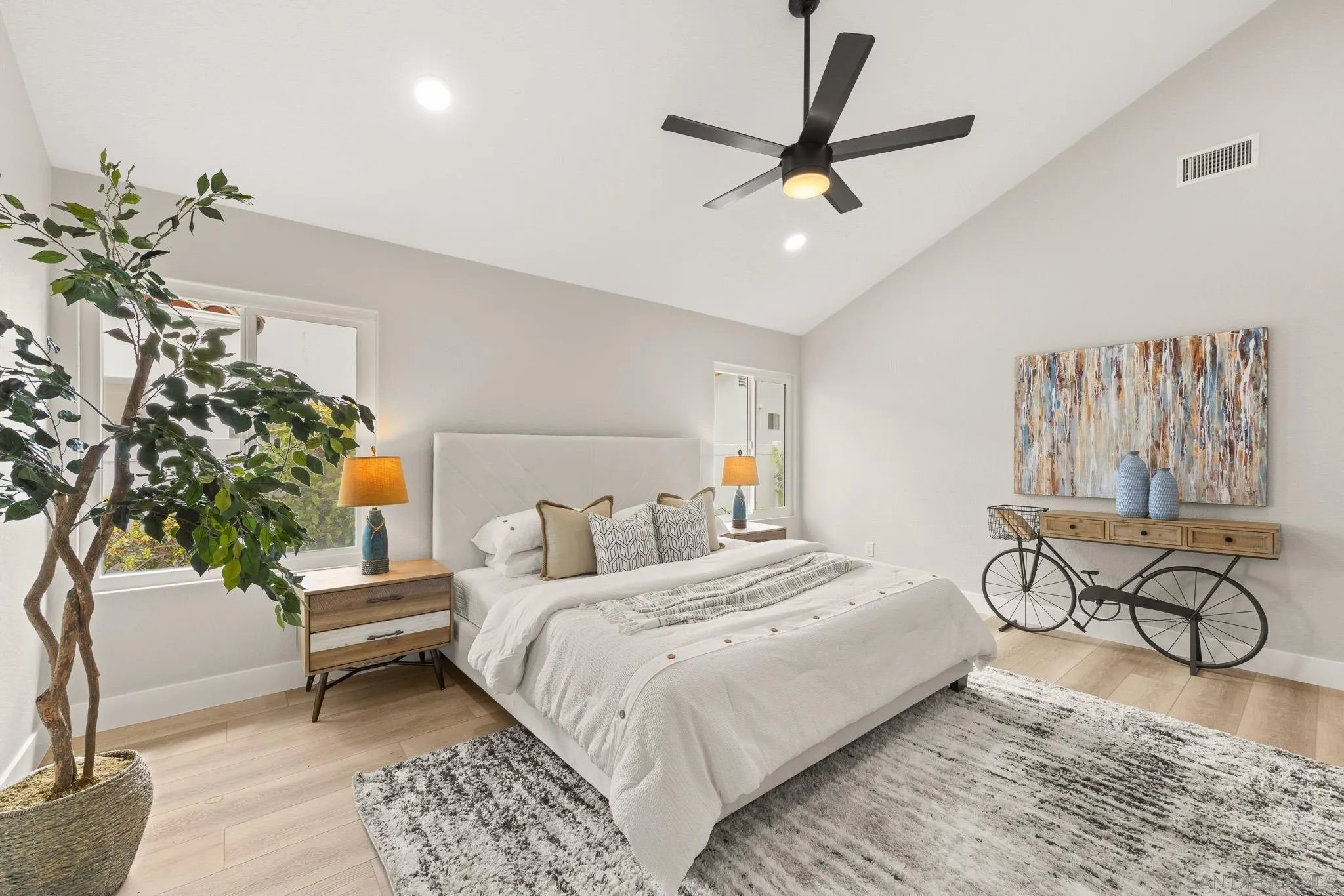 4661 Majorca Way Oceanside, CA 92056 - Photo 31 of 64 a bedroom with a large bed and a couch