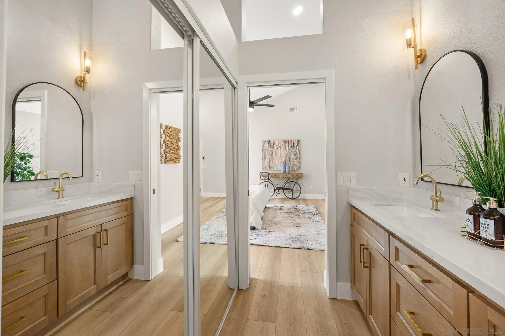 4661 Majorca Way Oceanside, CA 92056 - Photo 33 of 64 a spacious bathroom with a double vanity sink a mirror and a shower