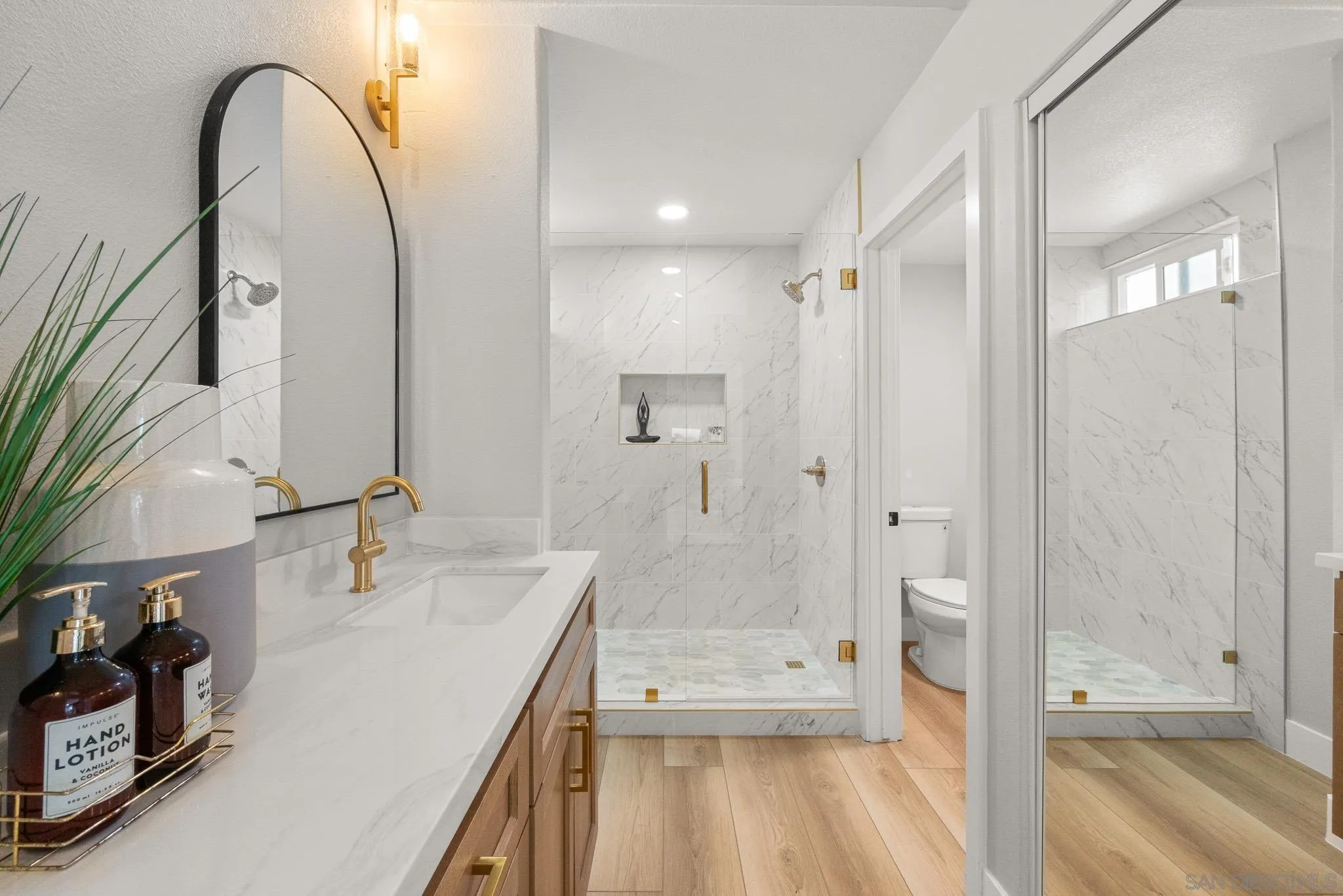 4661 Majorca Way Oceanside, CA 92056 - Photo 37 of 64 a bathroom with a sink a toilet and shower