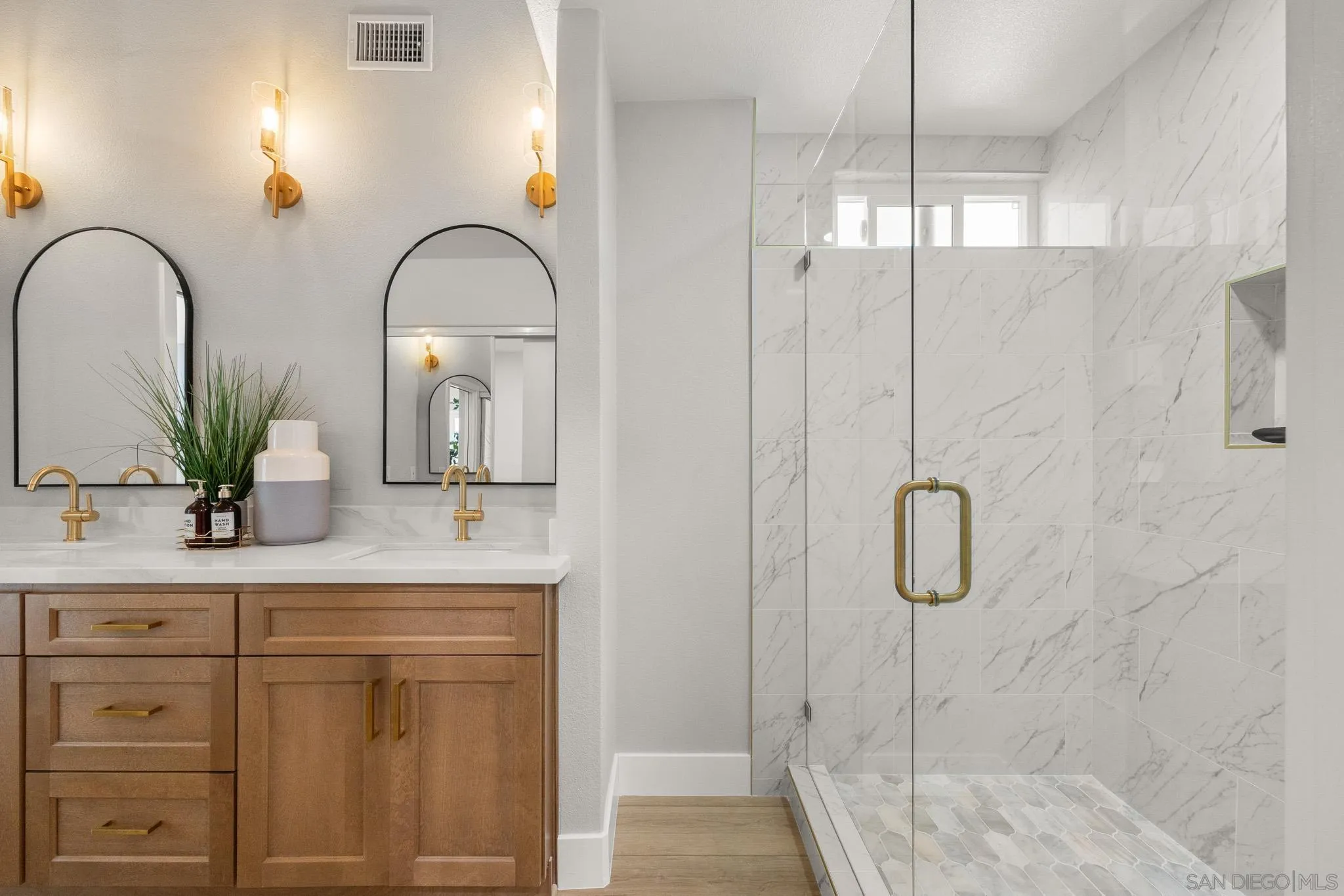 4661 Majorca Way Oceanside, CA 92056 - Photo 38 of 64 a bathroom with a shower sink and mirror