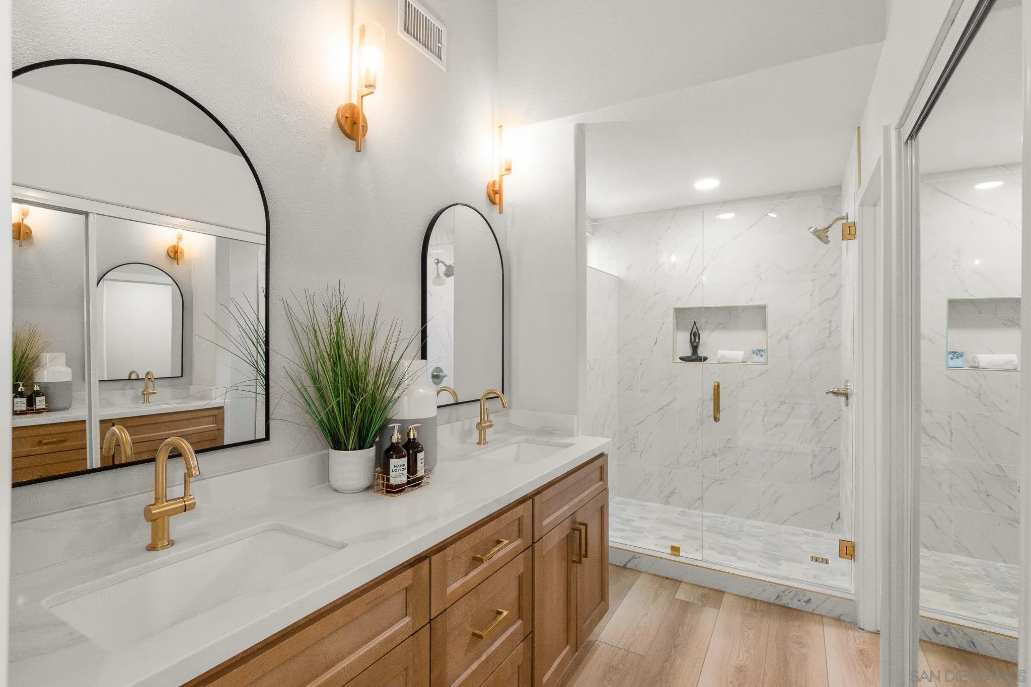 4661 Majorca Way Oceanside, CA 92056 - Photo 39 of 64 a bathroom with a double vanity sink mirror and shower