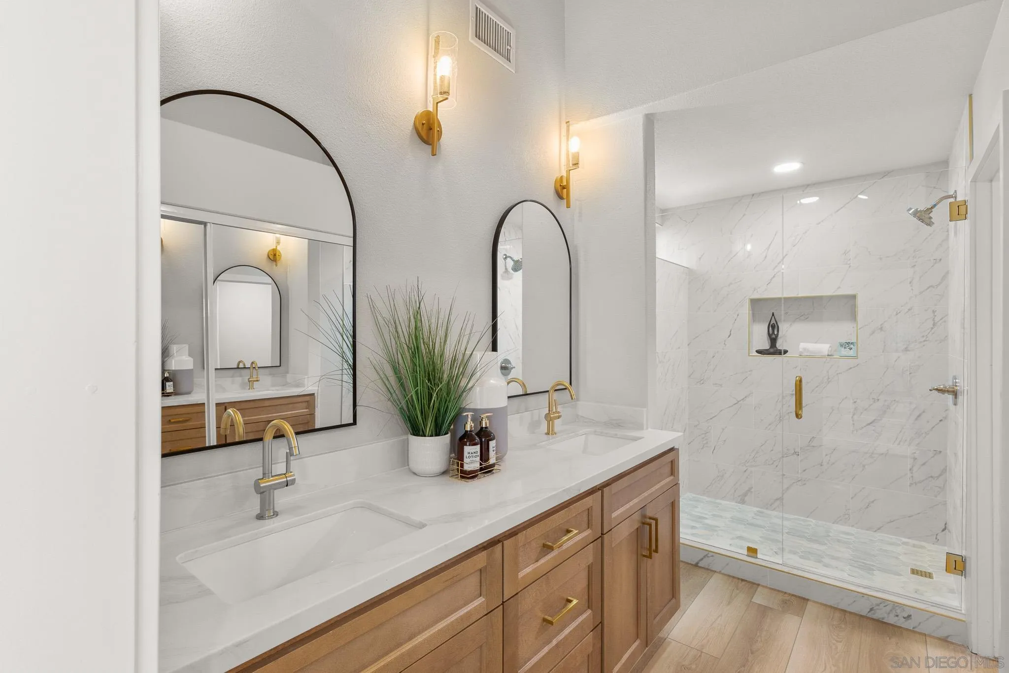 4661 Majorca Way Oceanside, CA 92056 - Photo 40 of 64 a bathroom with a double vanity sink mirror and shower
