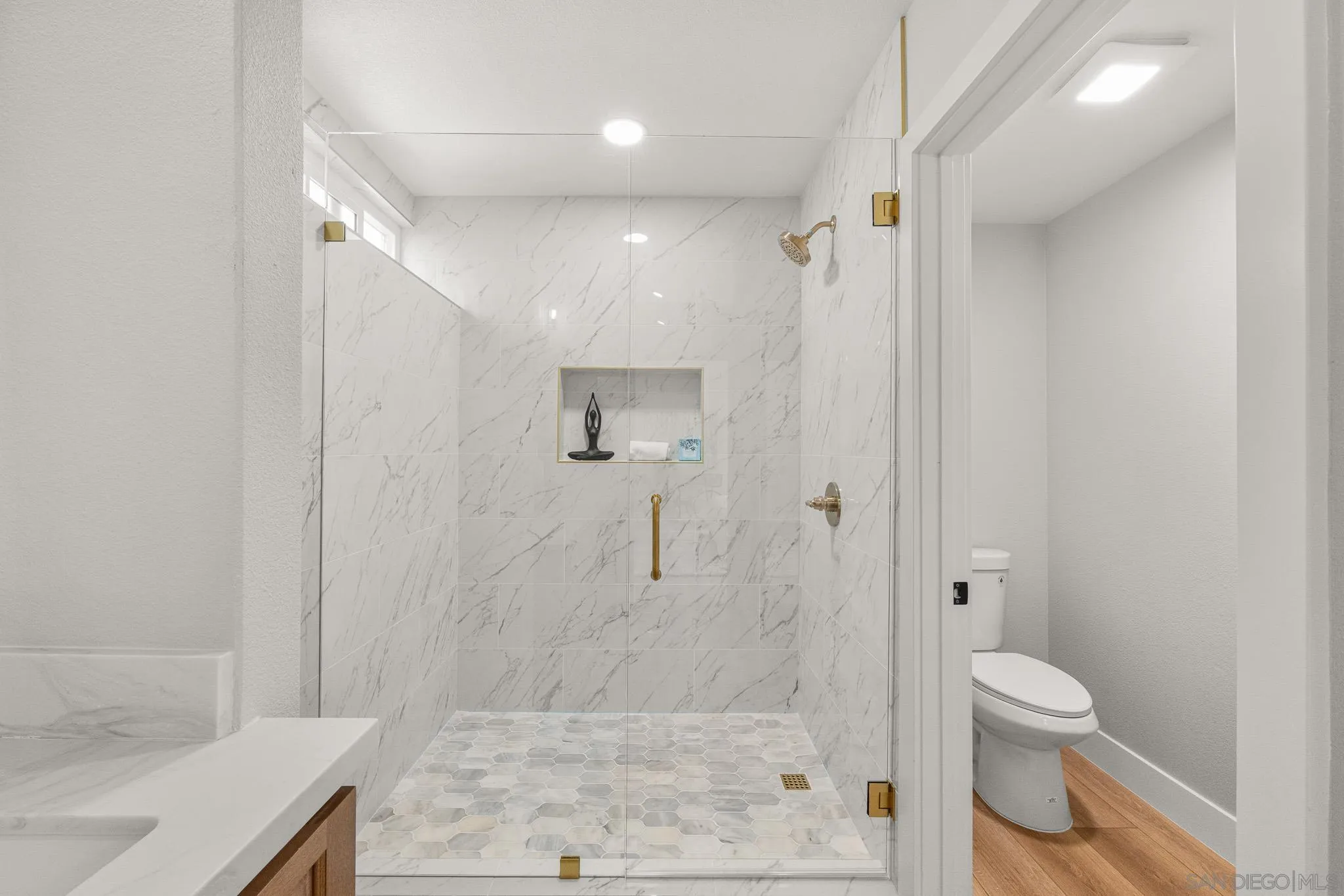 4661 Majorca Way Oceanside, CA 92056 - Photo 41 of 64 a bathroom with a granite countertop shower a toilet and a sink