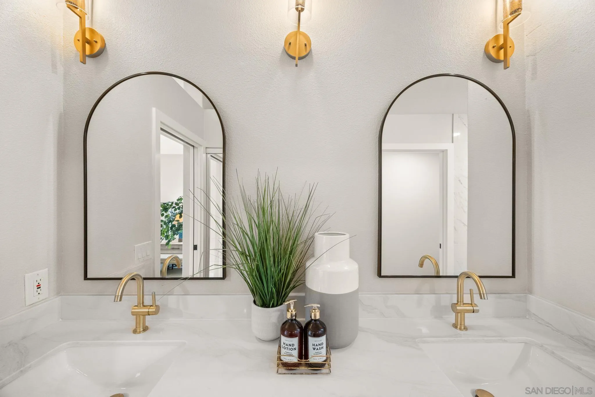 4661 Majorca Way Oceanside, CA 92056 - Photo 43 of 64 a bathroom with a sink and a mirror