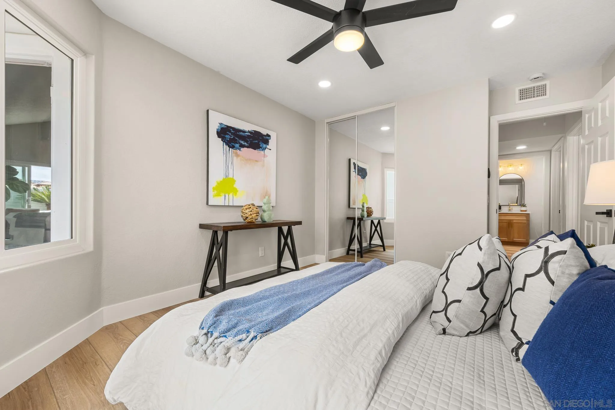 4661 Majorca Way Oceanside, CA 92056 - Photo 47 of 64 a bedroom with a bed and a window