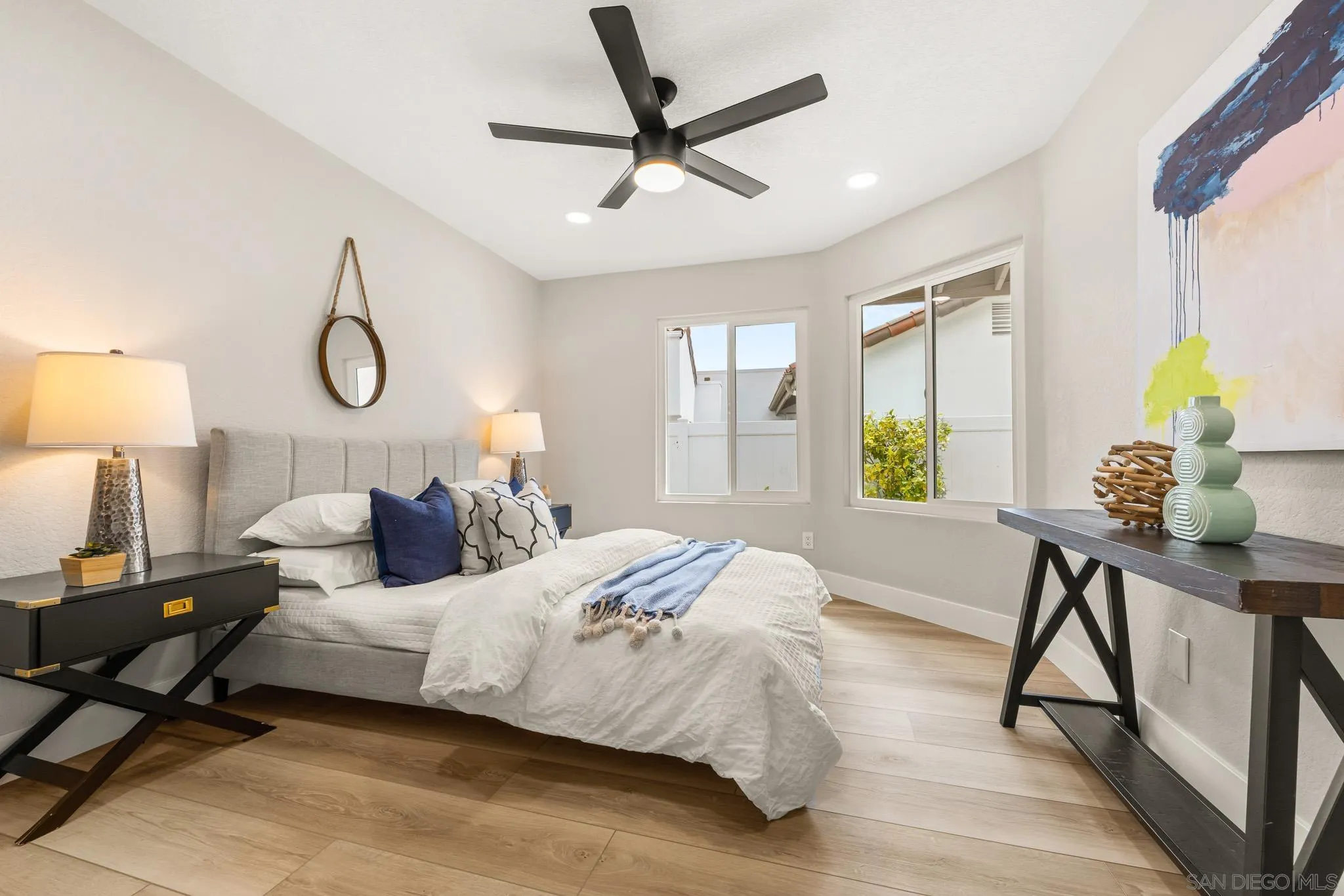 4661 Majorca Way Oceanside, CA 92056 - Photo 48 of 64 a bedroom with a bed and a table in it