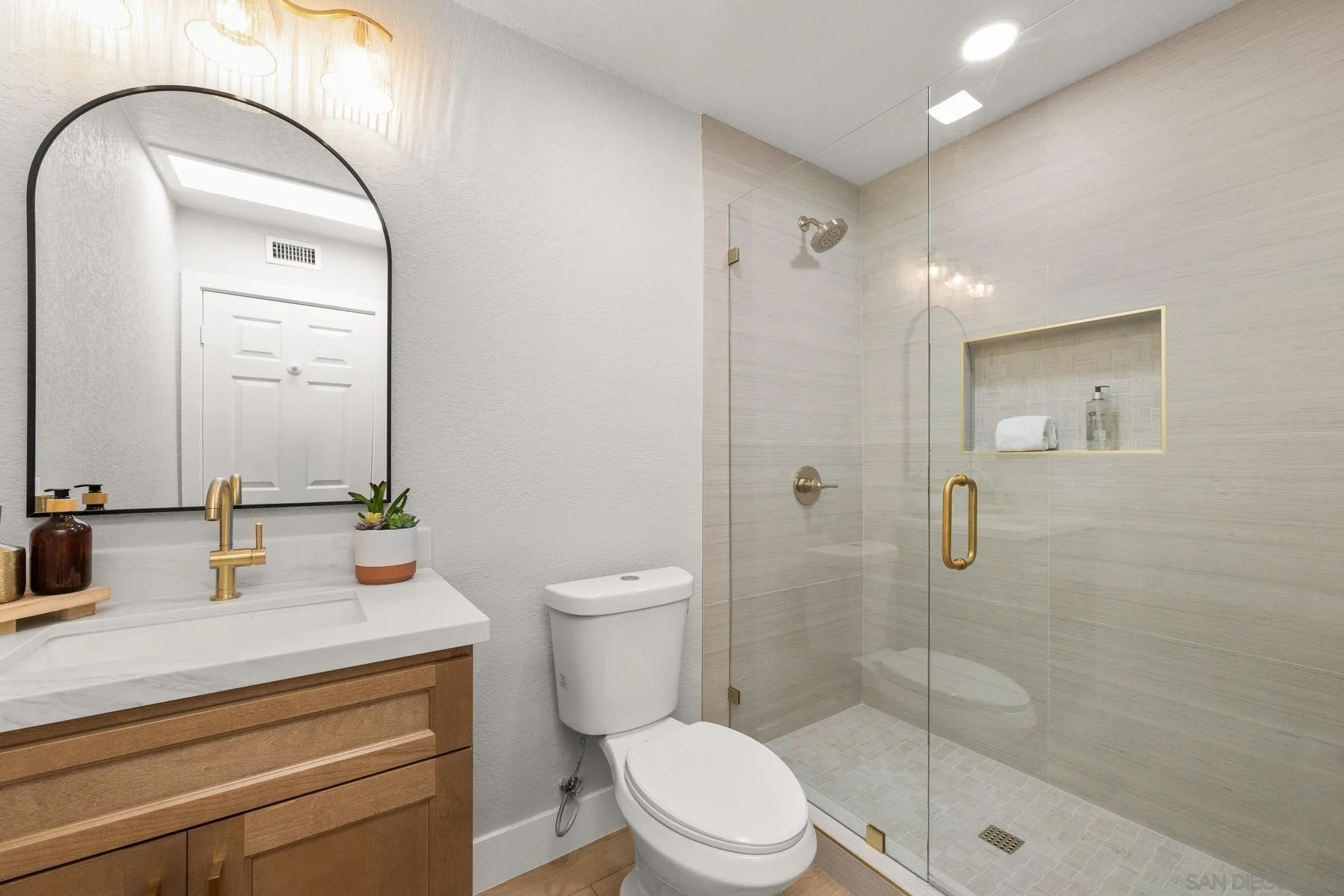 4661 Majorca Way Oceanside, CA 92056 - Photo 50 of 64 a bathroom with a sink a toilet and shower