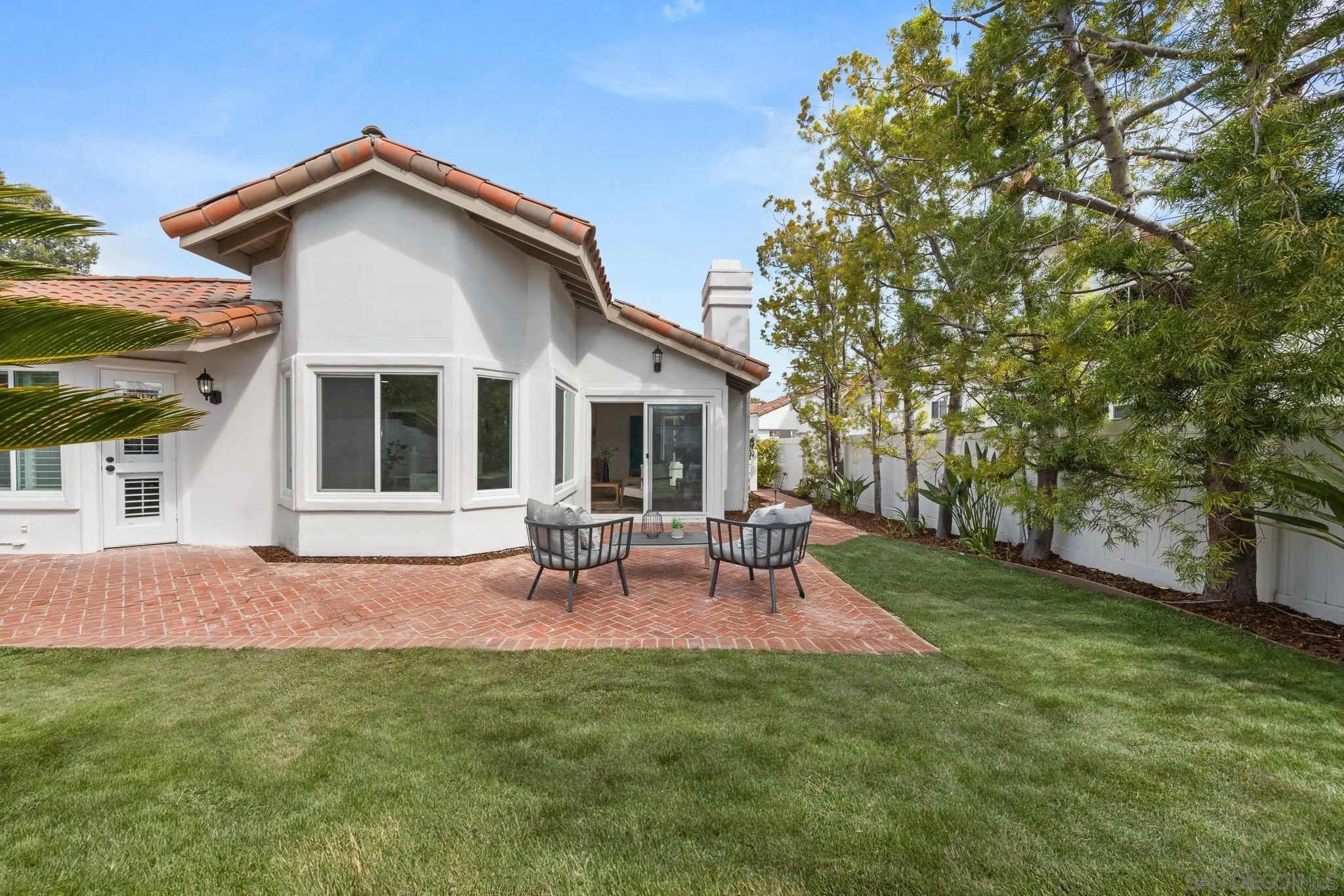 4661 Majorca Way Oceanside, CA 92056 - Photo 54 of 64 a front view of a house with a garden and patio