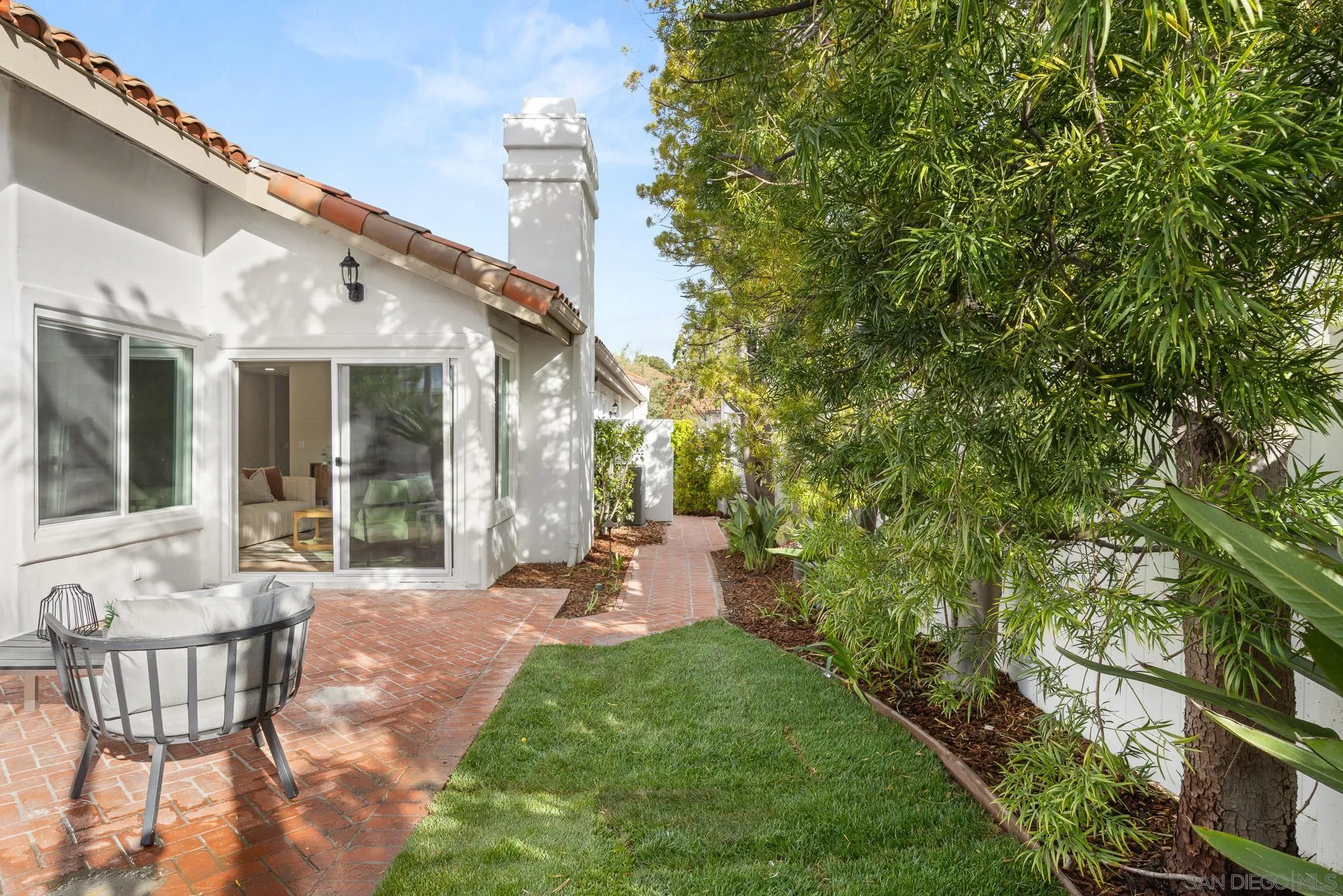 4661 Majorca Way Oceanside, CA 92056 - Photo 56 of 64 a view of a patio with table and chairs and potted plants