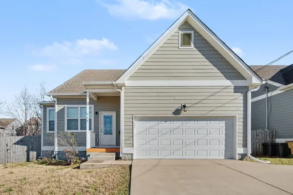 a view of a house with a backyard