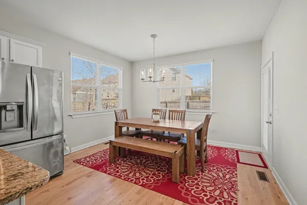 a dining room with furniture a rug and wooden floor