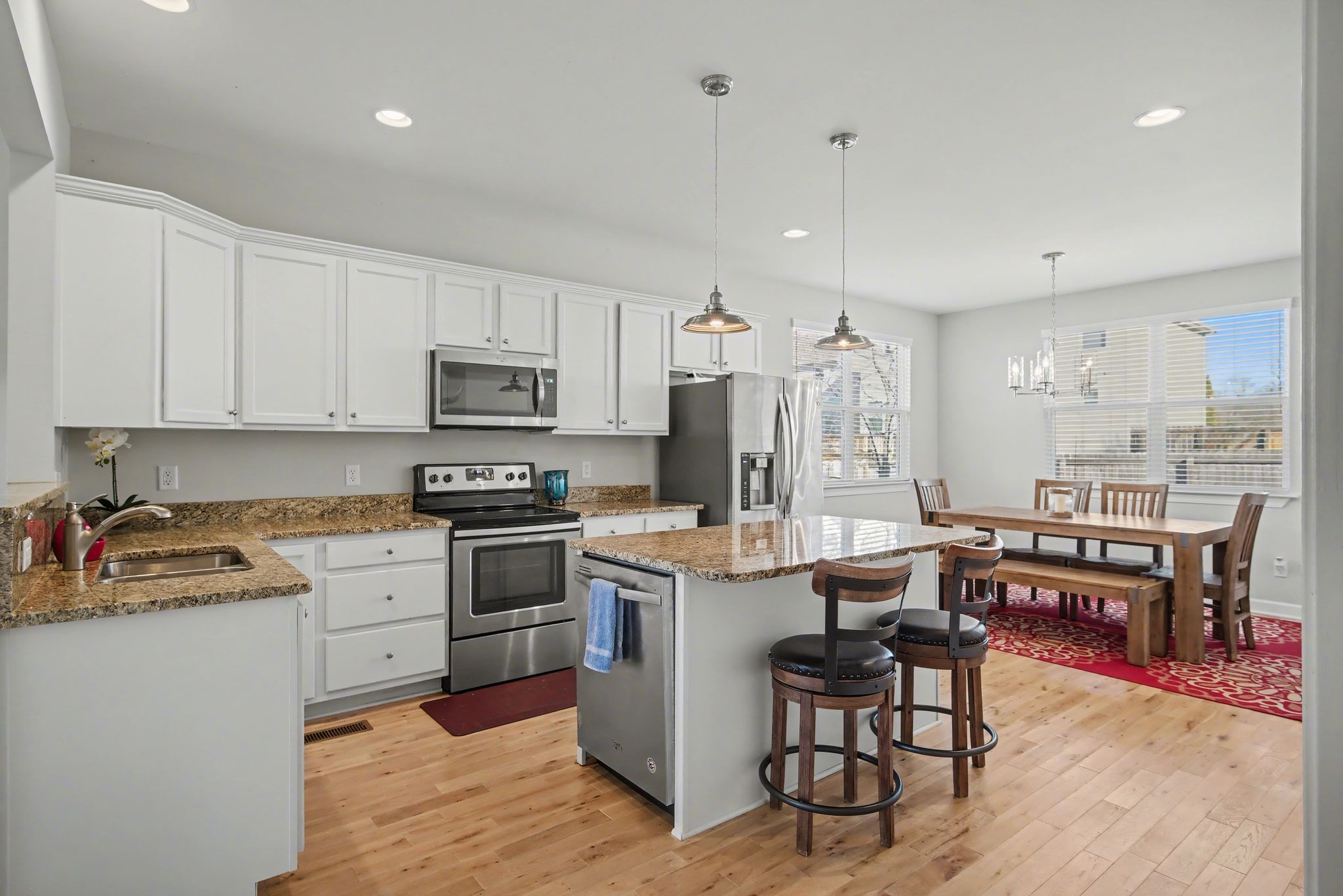 912 Pierce Road Madison, TN 37115 - Photo 12 of 32 a kitchen with kitchen island granite countertop wooden cabinets and stainless steel appliances