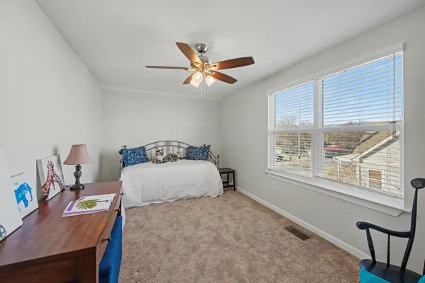 a bedroom with a bed and a window