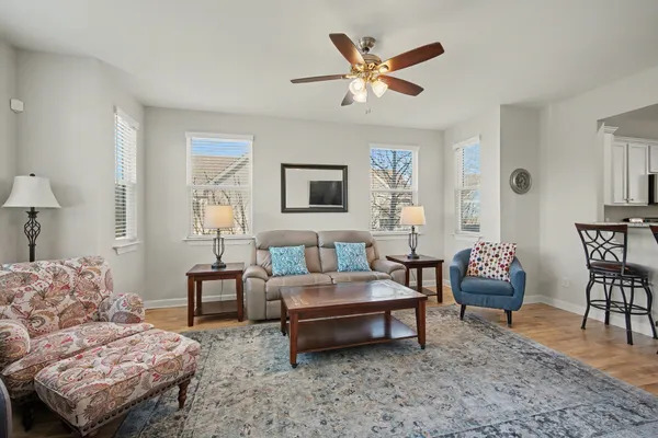 a living room with furniture a rug and a lamp