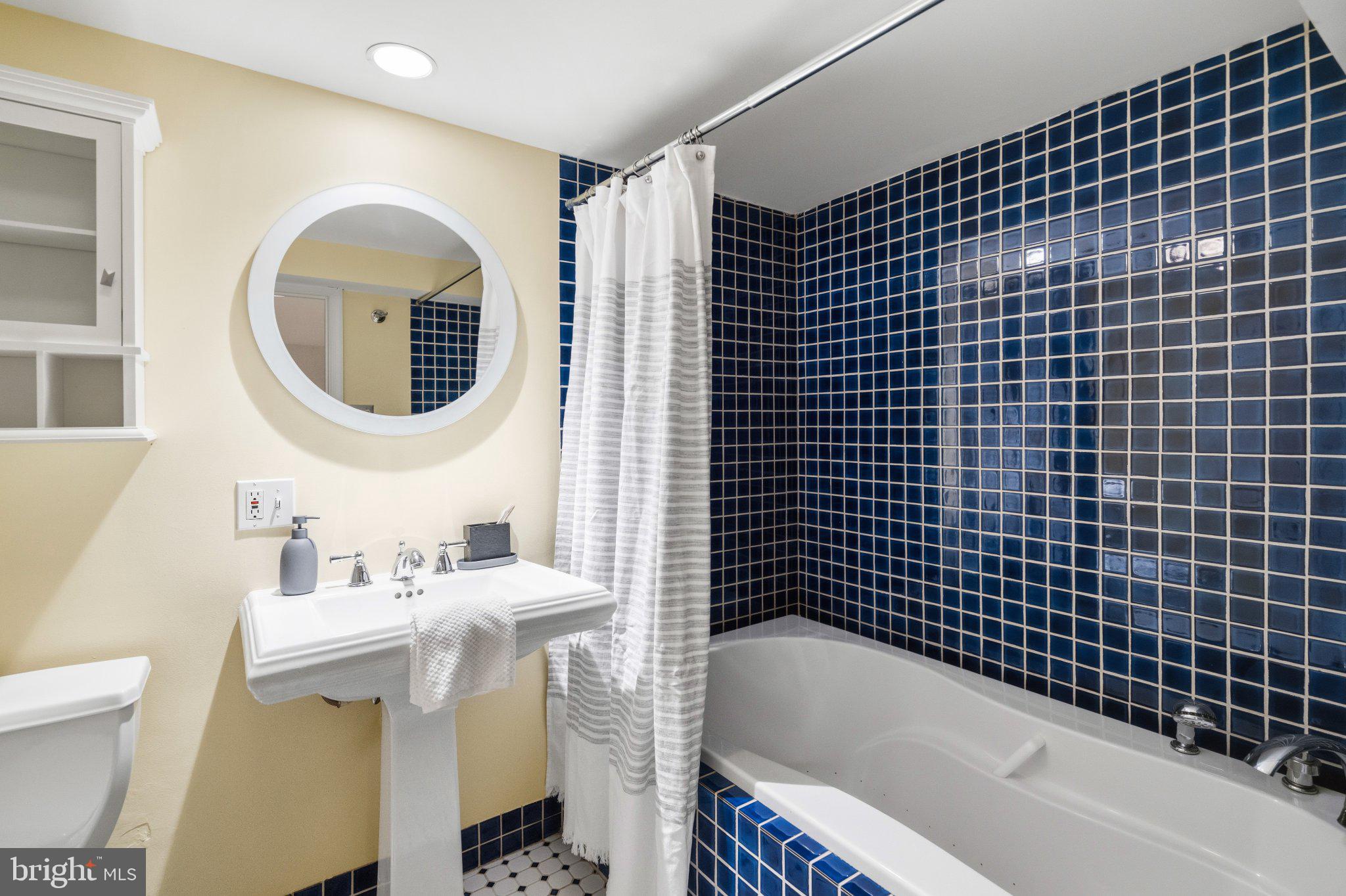 2934 Porter Street Northwest Washington, DC 20008 - Photo 31 of 33 Chic bathroom with vibrant blue tiles.