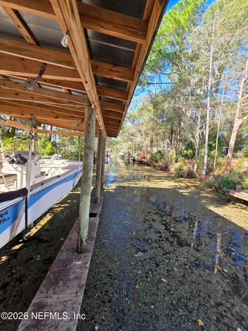 a living room with furniture a chandelier fan and a window