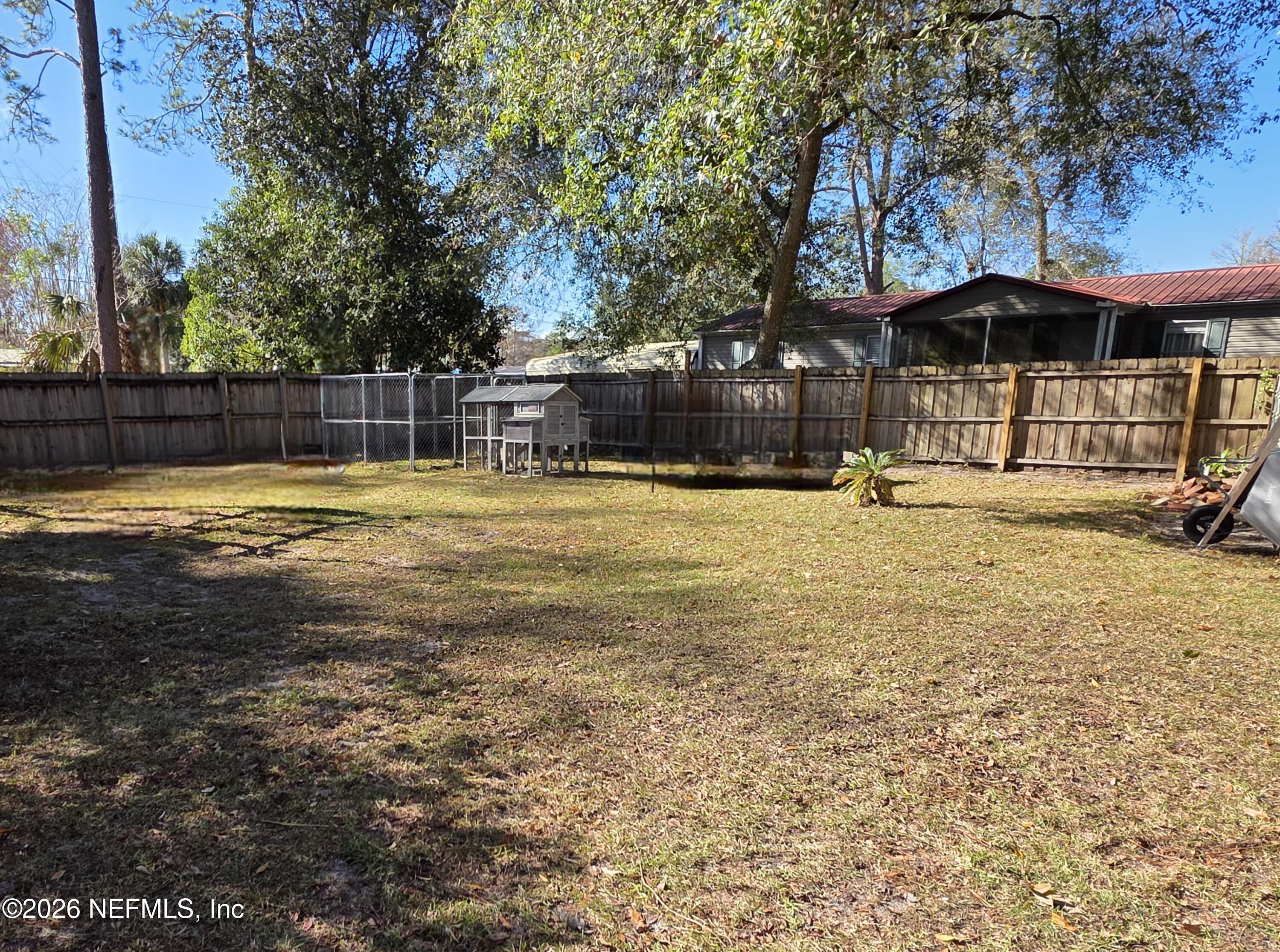 108 Creekside Road Satsuma, FL 32189 - Photo 16 of 51 a swimming pool with outdoor seating and yard