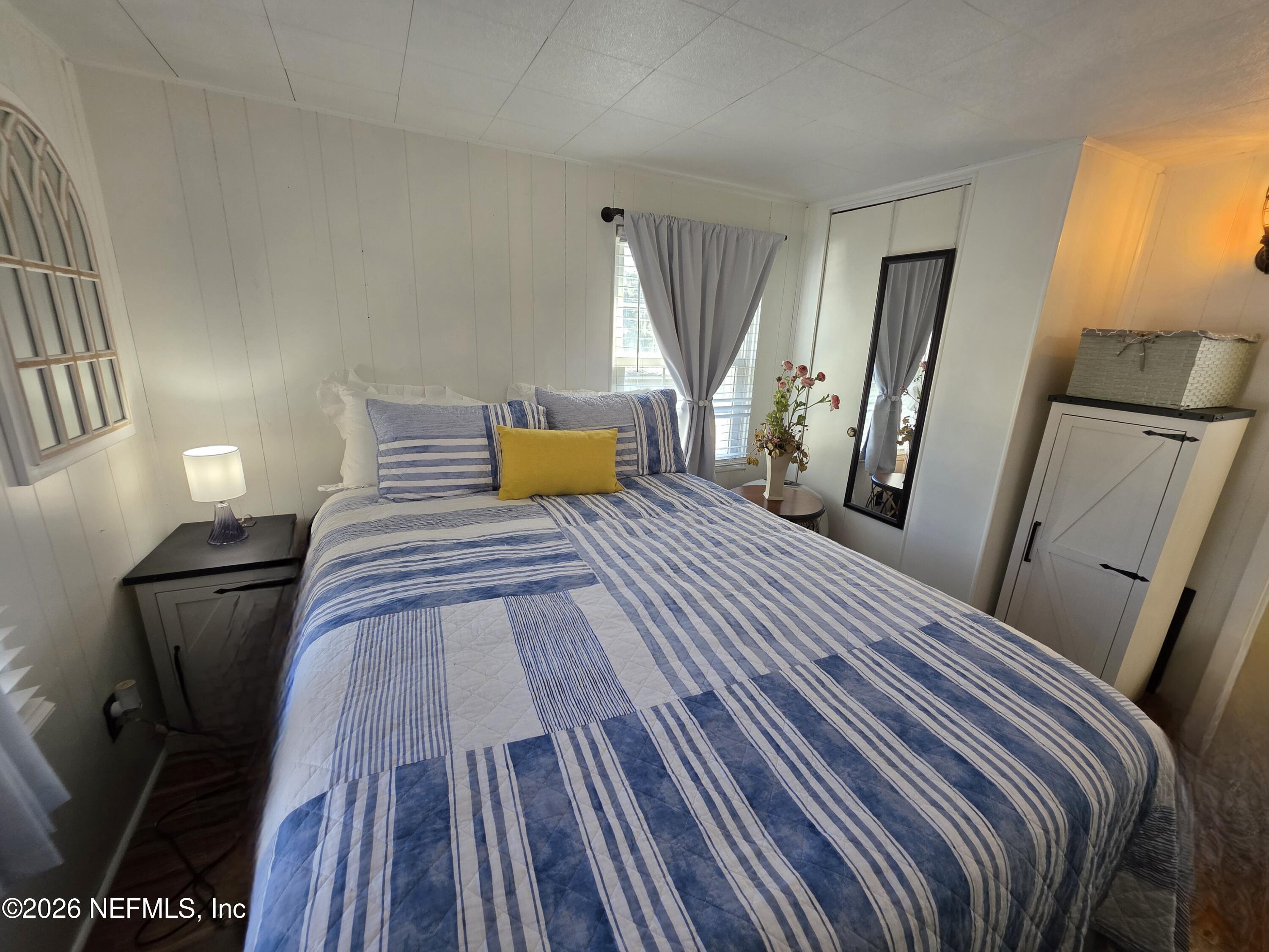 108 Creekside Road Satsuma, FL 32189 - Photo 47 of 51 a bedroom with a bed and wooden floor