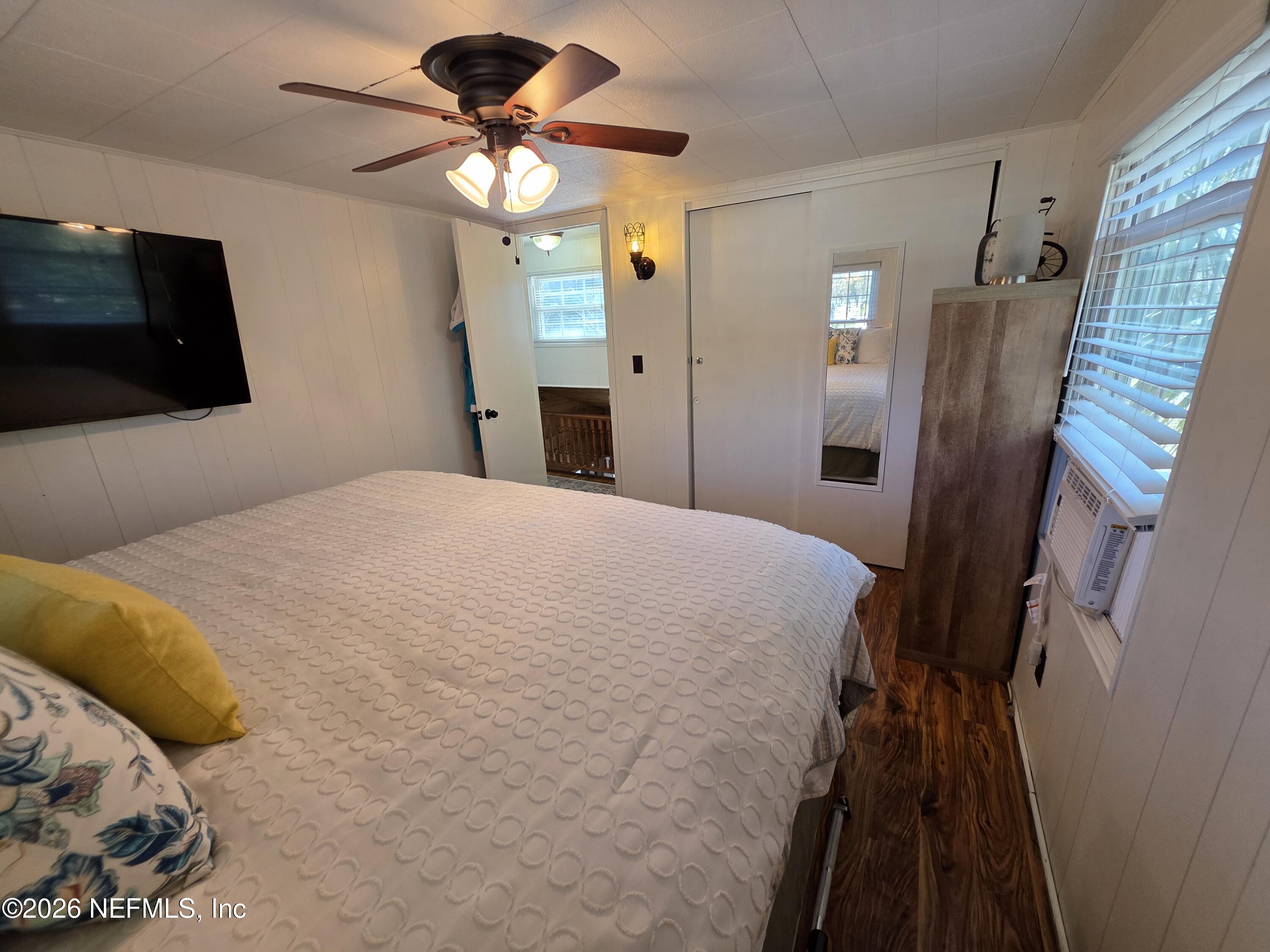 108 Creekside Road Satsuma, FL 32189 - Photo 50 of 51 a bedroom with a bed and a flat tv screen on dresser