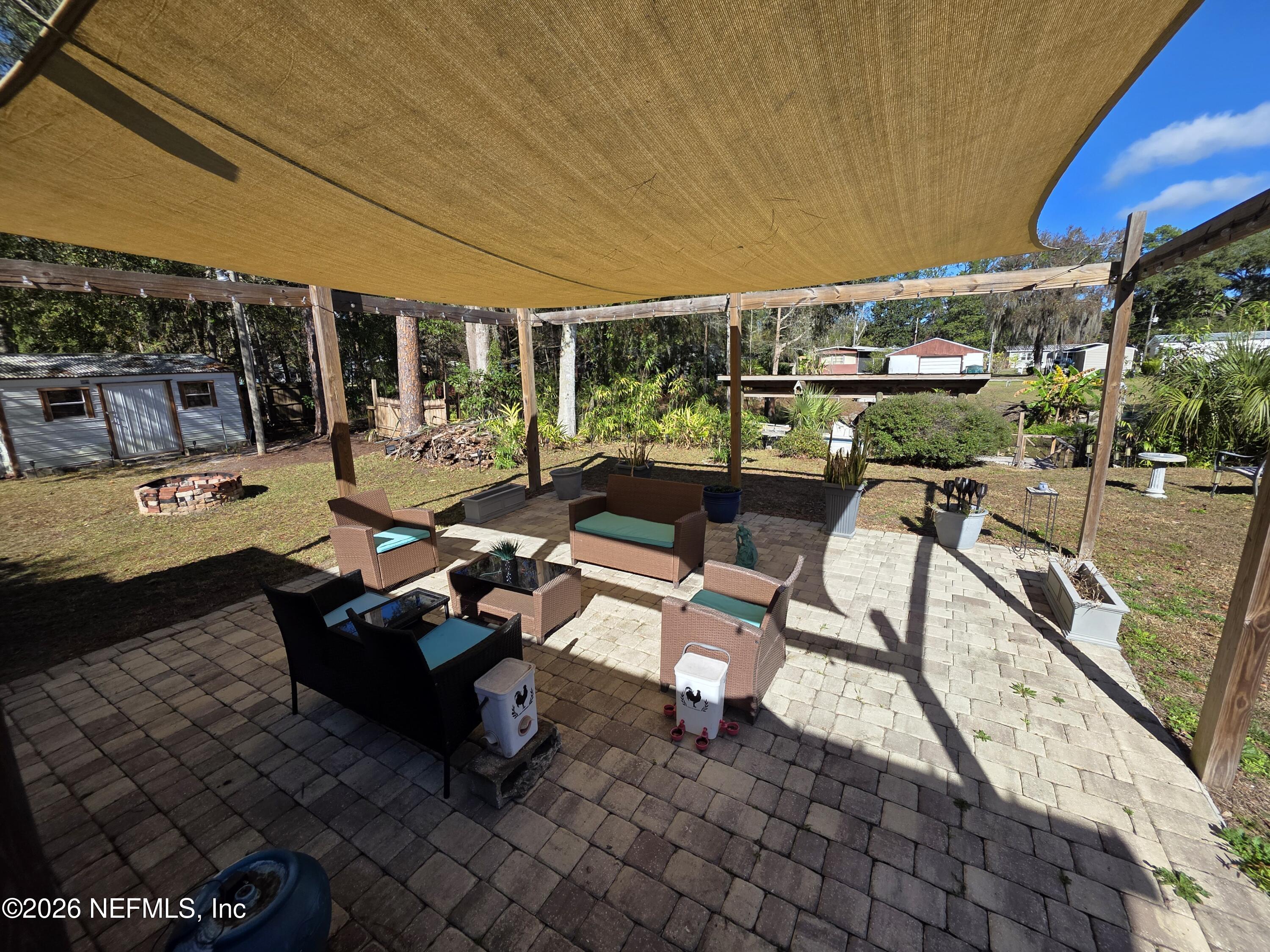 108 Creekside Road Satsuma, FL 32189 - Photo 7 of 51 a building outdoor space with patio furniture and potted plants