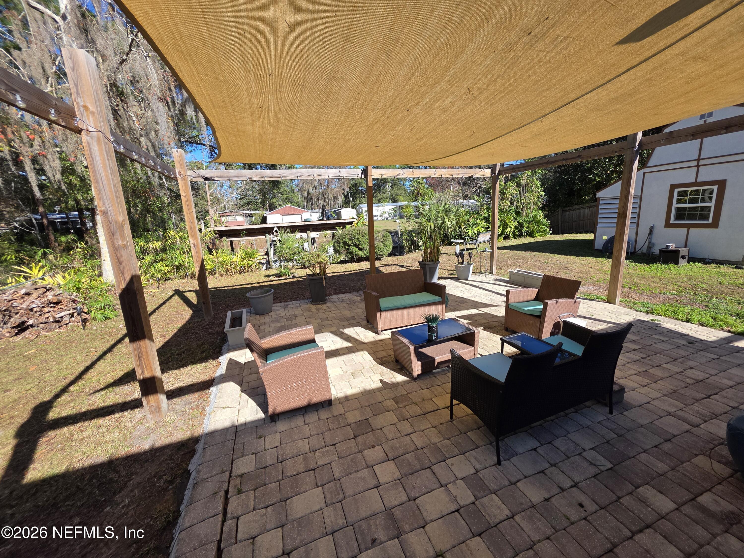108 Creekside Road Satsuma, FL 32189 - Photo 8 of 51 a outdoor space with patio the couches and a dining table with garden view