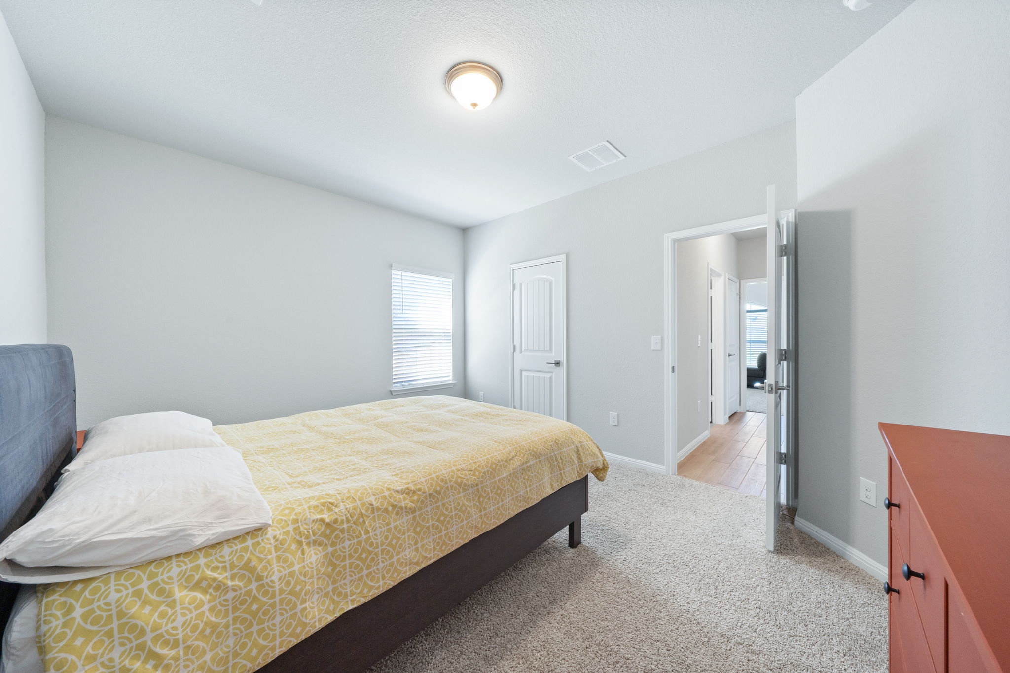 2412 Starhill Ranch Street Georgetown, TX 78628 - Photo 10 of 40 A restful bedroom with soft carpeting and a window for natural light.
