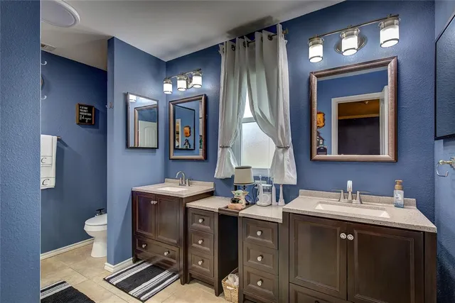 a bathroom with a sink double vanity and a mirror