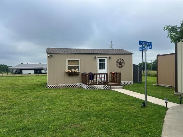 a view of a house with a yard and porch