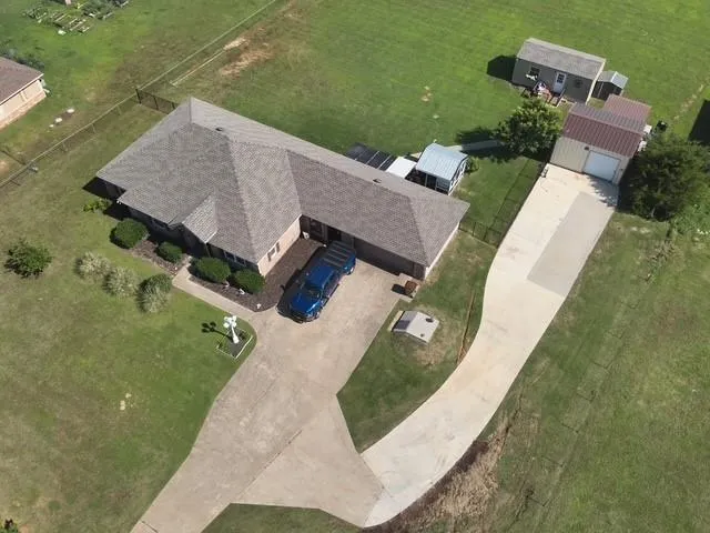 an aerial view of a house with a yard