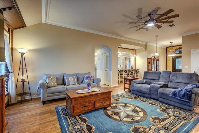 a living room with furniture and a chandelier