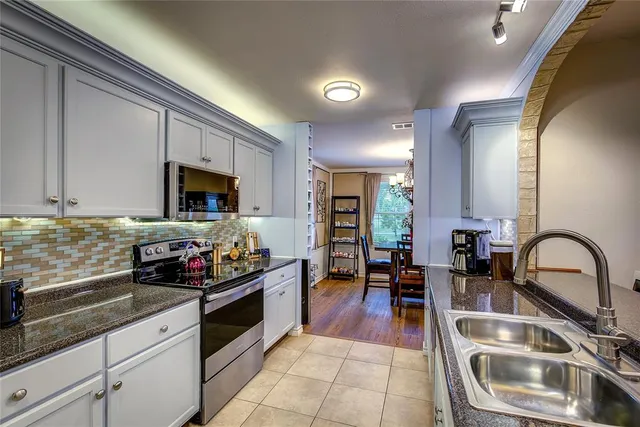 a kitchen with a sink and cabinets