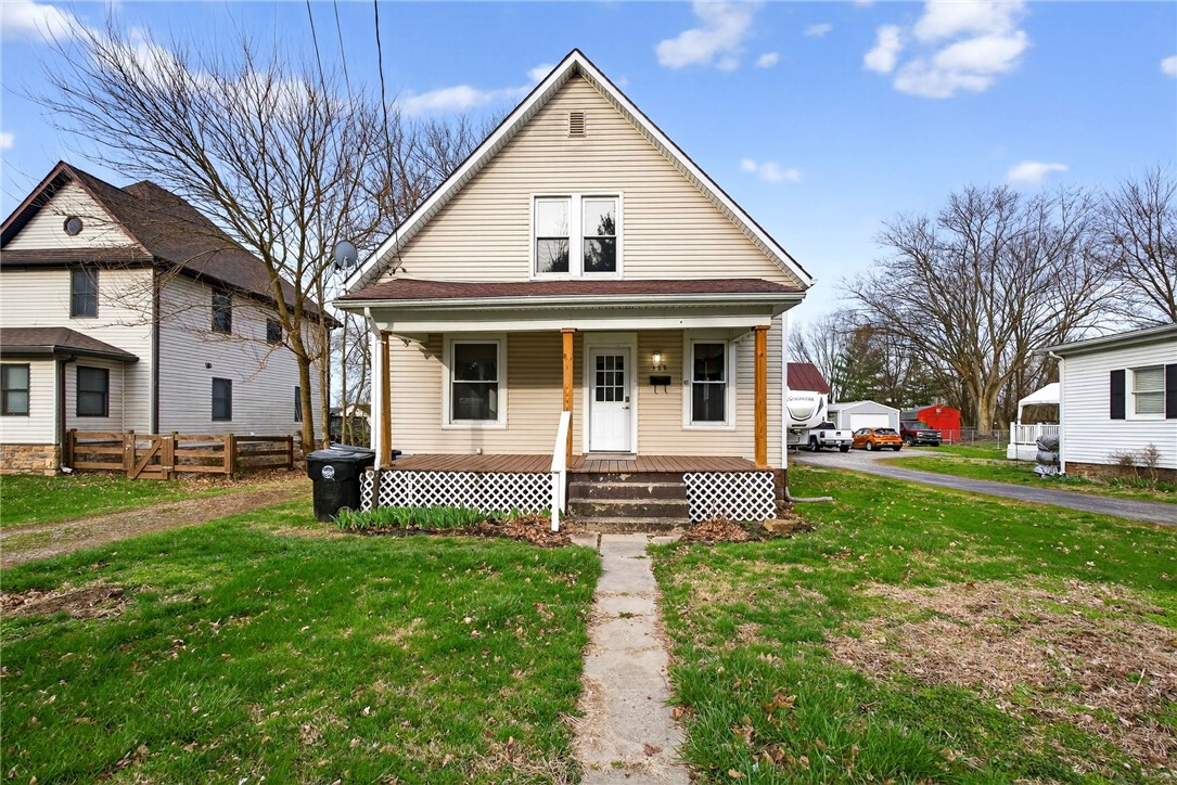585 North Spring Street Wilmington, OH 45177 - Photo 1 of 21 This charming home features a welcoming porch, a verdant lawn, and a classic pitched roof.