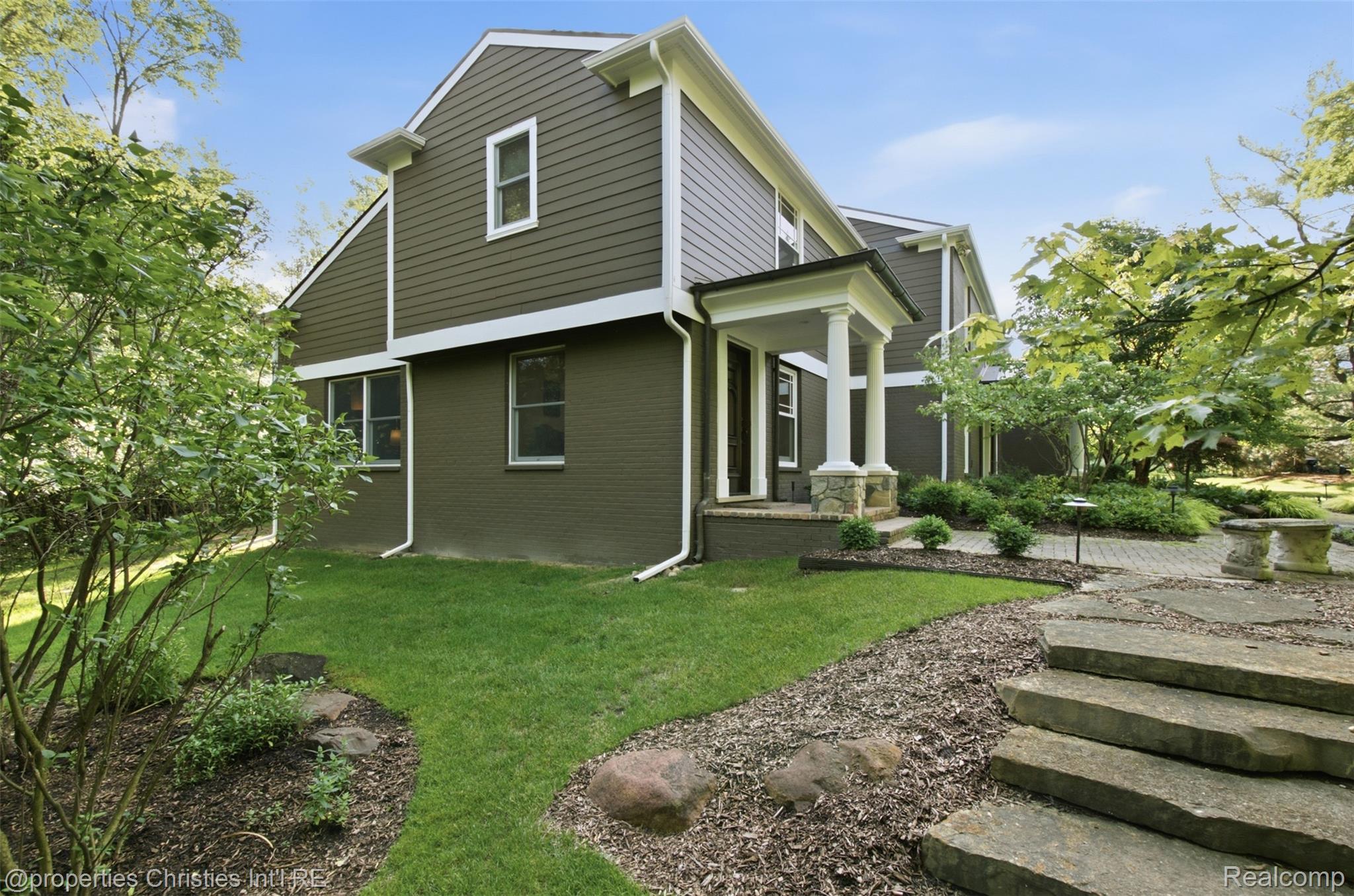 25235 Canterbury Road Franklin, MI 48025 - Photo 38 of 56 Exterior featuring both horizontal siding and brick finishes in an earthy tone, complemented by white trim
