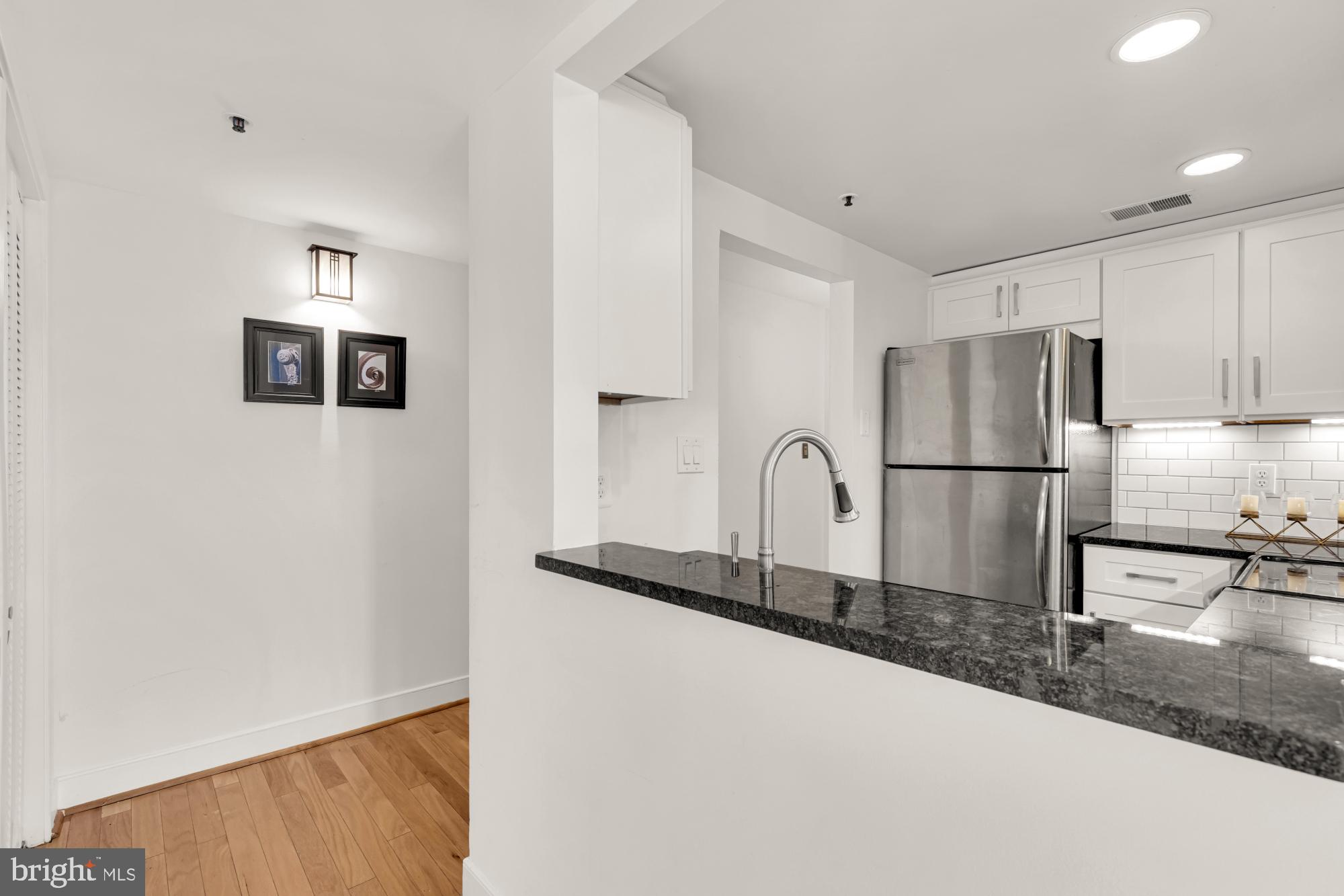 1727 R Street Northwest, Unit 402 Washington, DC 20009 - Photo 16 of 35 Kitchen Island open to Living Room