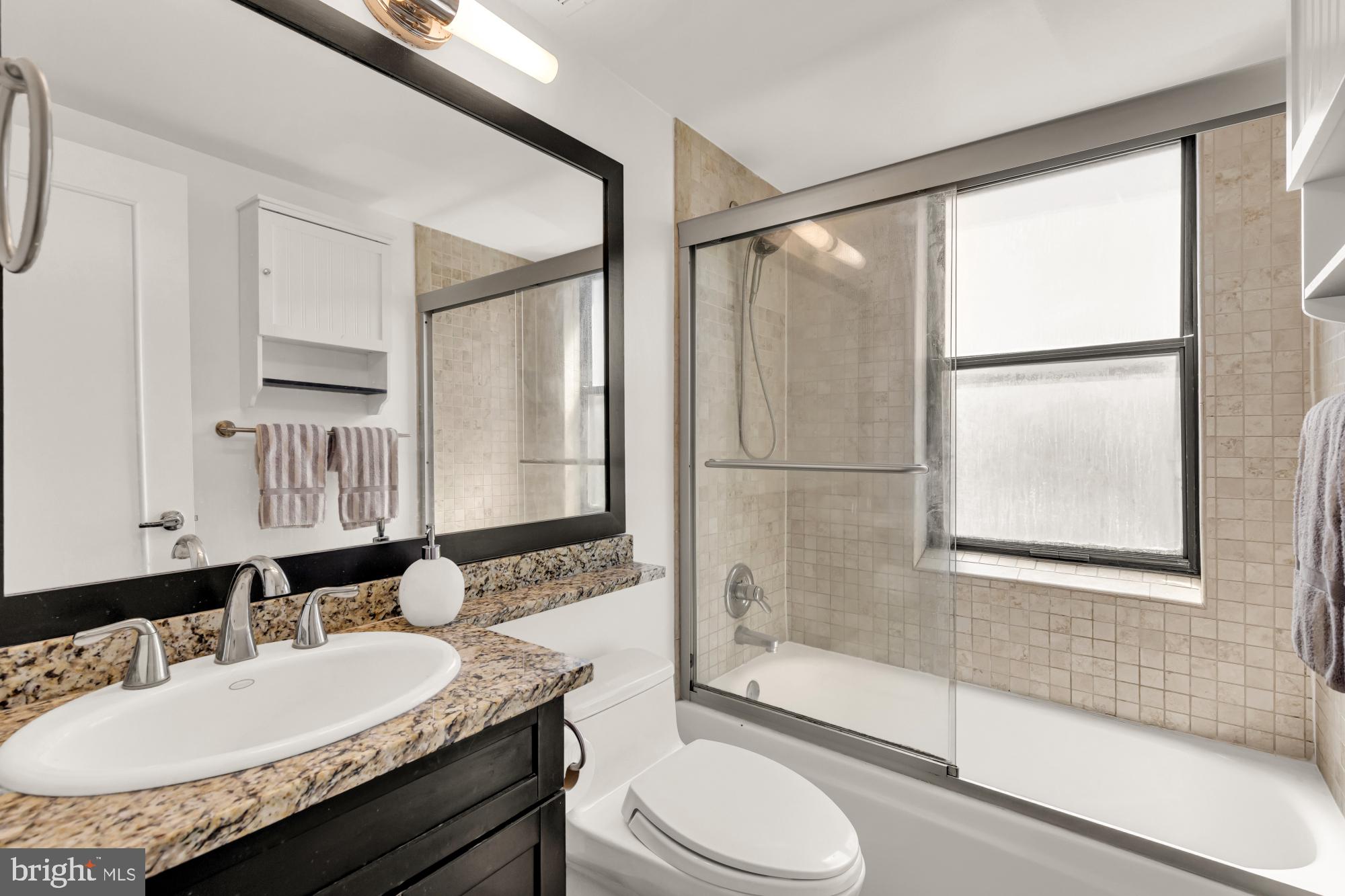 1727 R Street Northwest, Unit 402 Washington, DC 20009 - Photo 23 of 37 a bathroom with a granite countertop sink toilet and shower