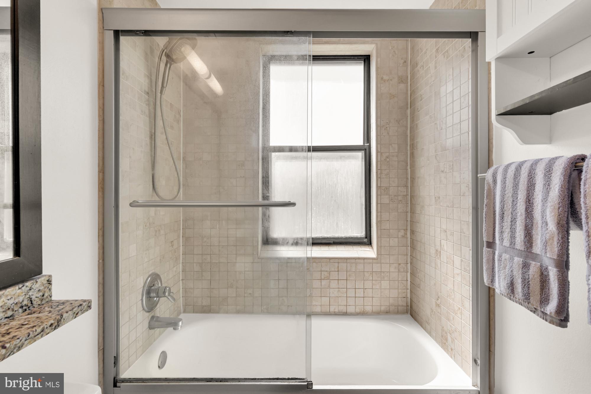 1727 R Street Northwest, Unit 402 Washington, DC 20009 - Photo 25 of 37 a bathroom with a bathtub and a shower