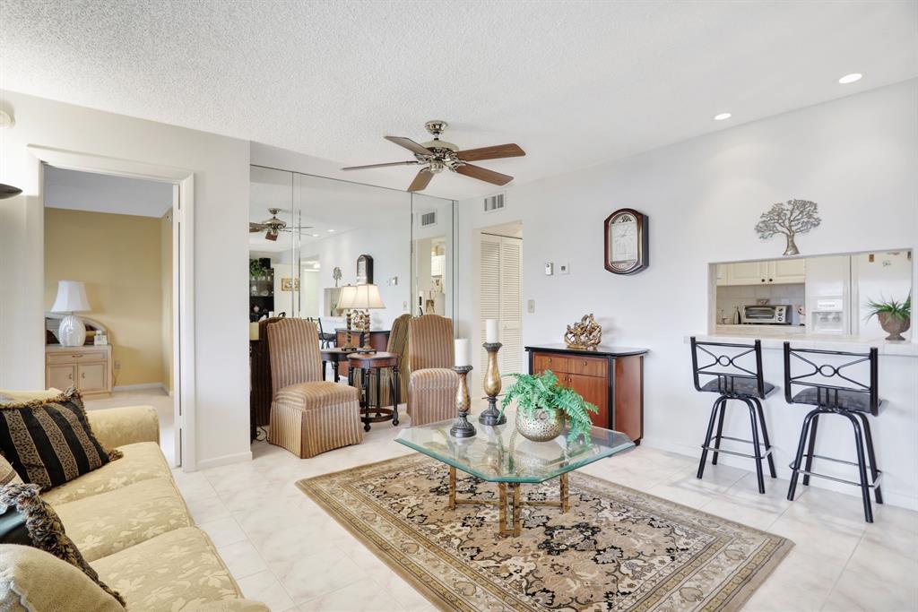 330 Southeast 20th Avenue, Unit 307 Deerfield Beach, FL 33441 - Photo 14 of 48 a living room with furniture and wooden floor